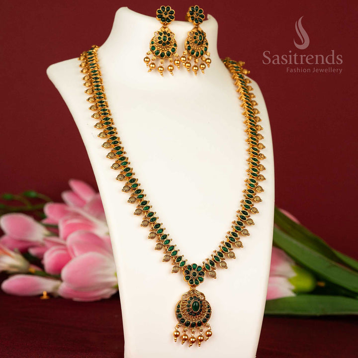 Divine temple style long haram necklace with green stones and floral matte gold detailing – a graceful jewellery piece – sasitrends