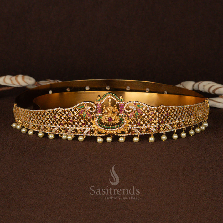 Exquisite matte gold-plated Lakshmi design temple hip belt featuring a regal mesh pattern, embellished with ruby-green AD stones and delicate pearl drops - Sasitrends