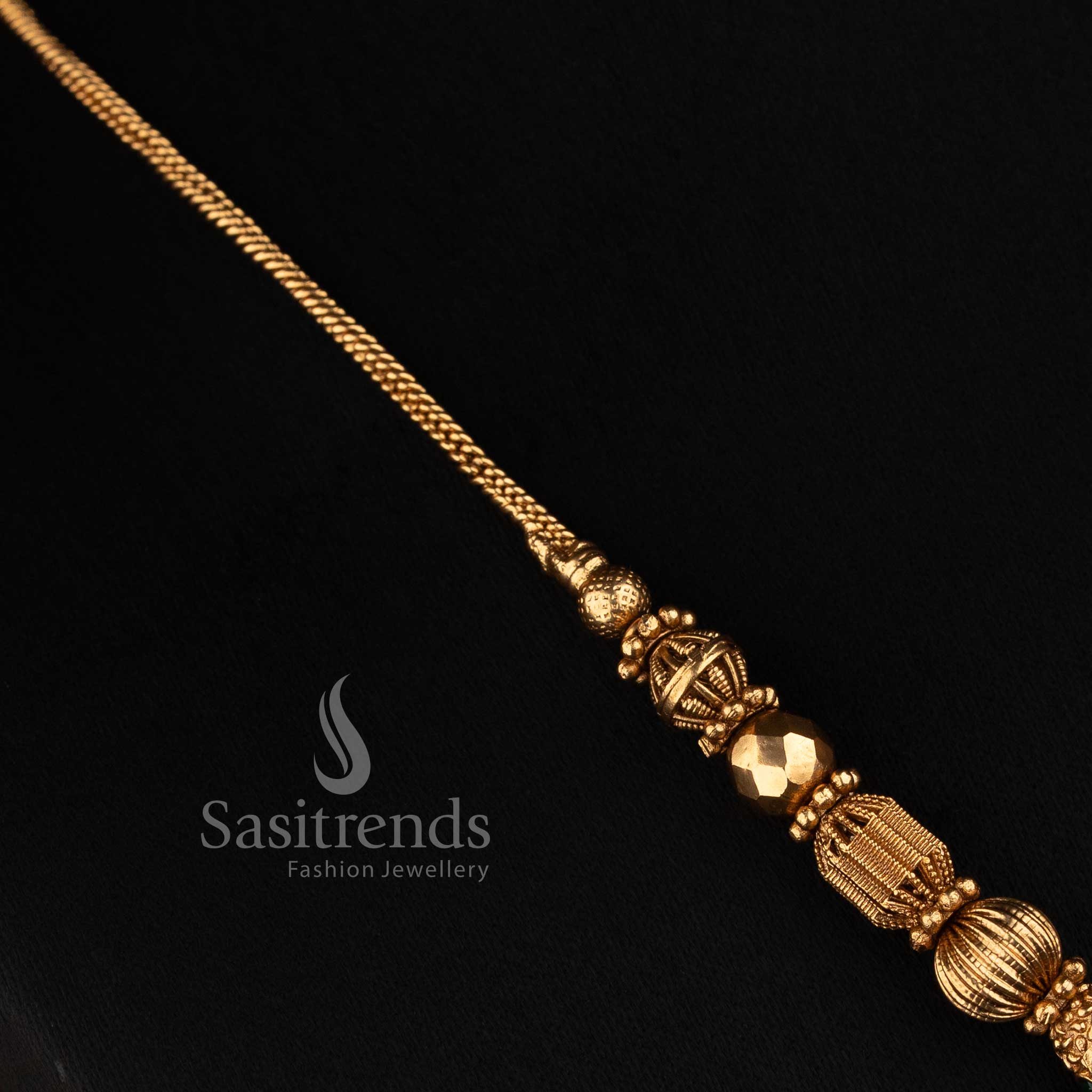 Traditional matte gold plated temple necklace featuring a fine ball chain, sculpted patterned beads, faceted accents and decorative side motifs by Sasitrends