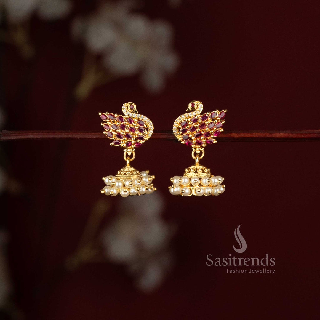 Sasitrends peacock motif jhumka earrings with ruby stones and layered pearl cluster drops 
