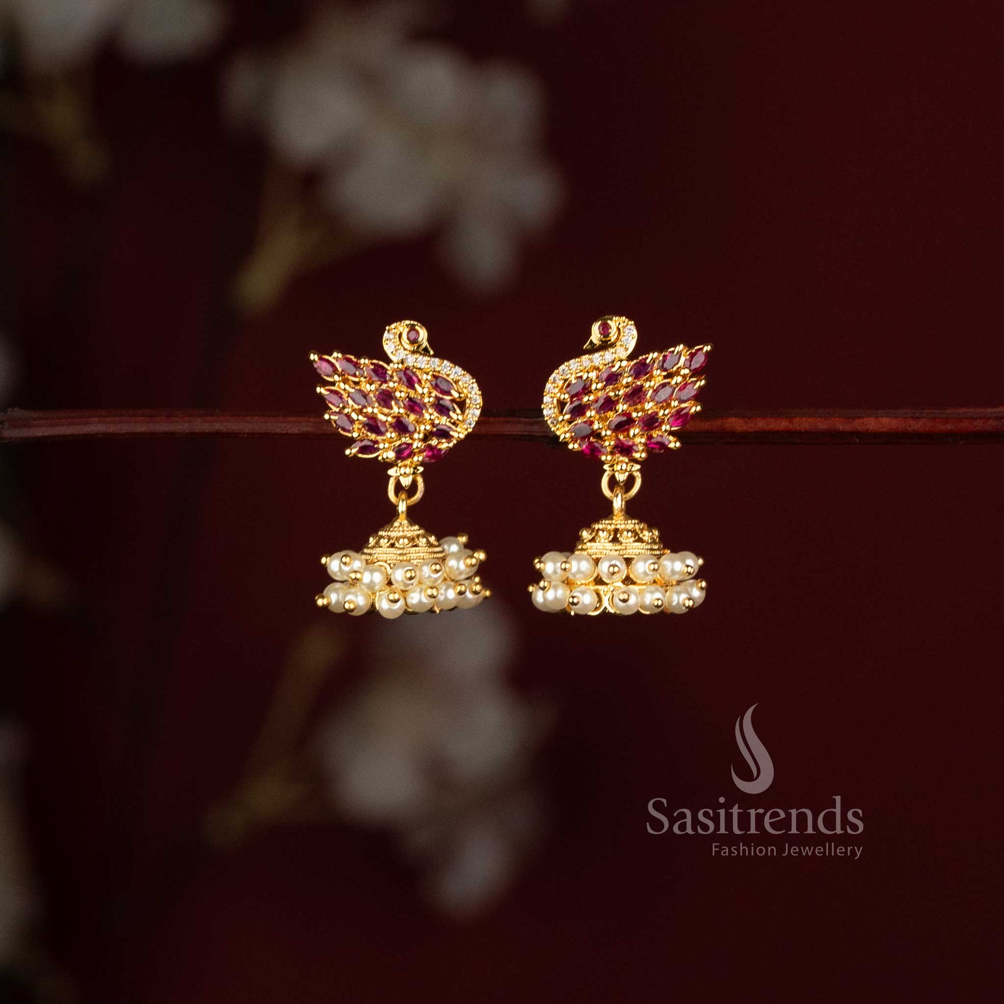 Sasitrends peacock motif jhumka earrings with ruby stones and layered pearl cluster drops 