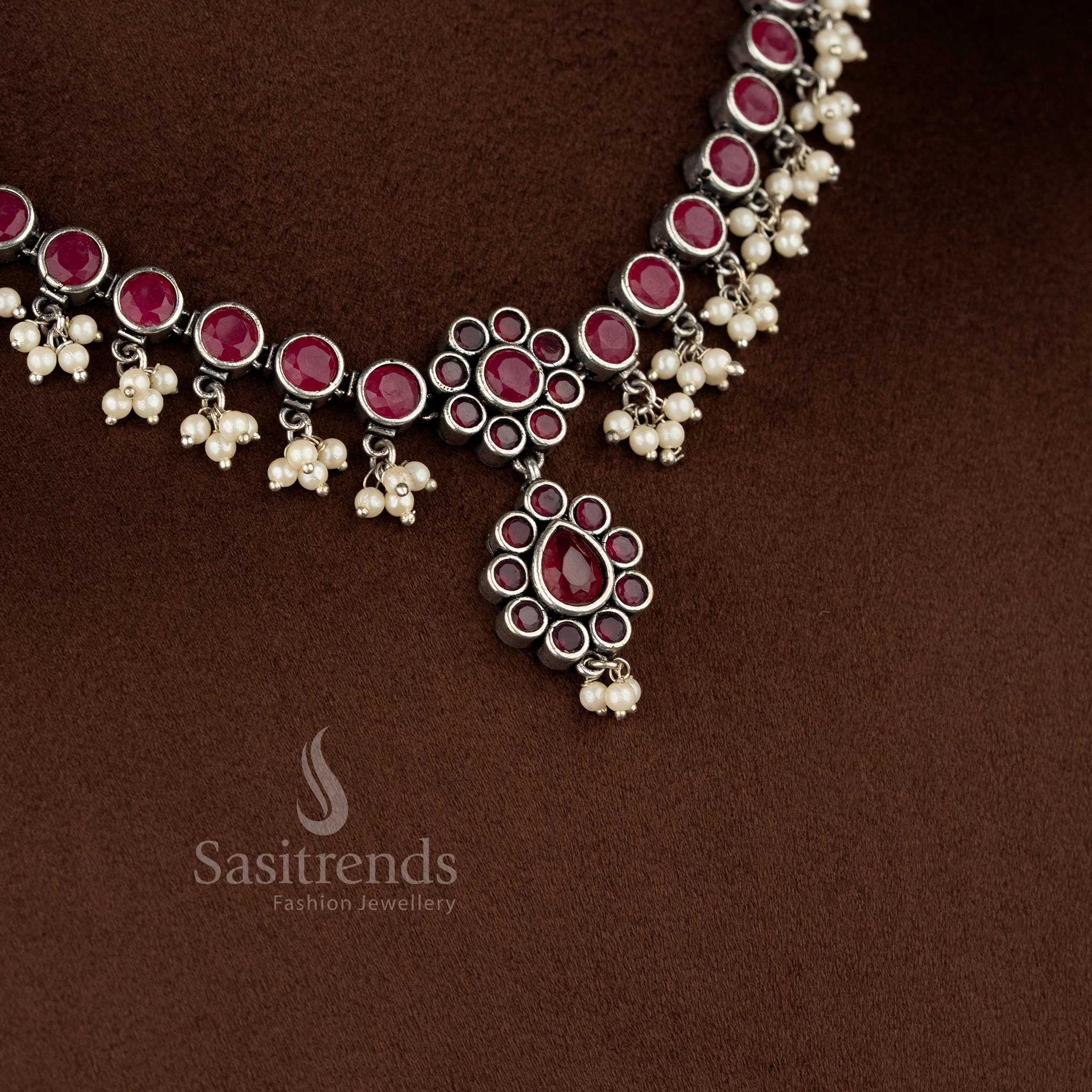 Traditional oxidised ruby stone necklace set with floral framework and delicate pearl drop detailing - Sasitrends
