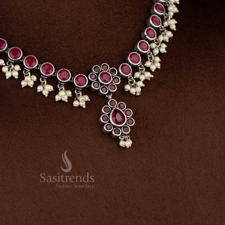 Traditional oxidised ruby stone necklace set with floral framework and delicate pearl drop detailing - Sasitrends