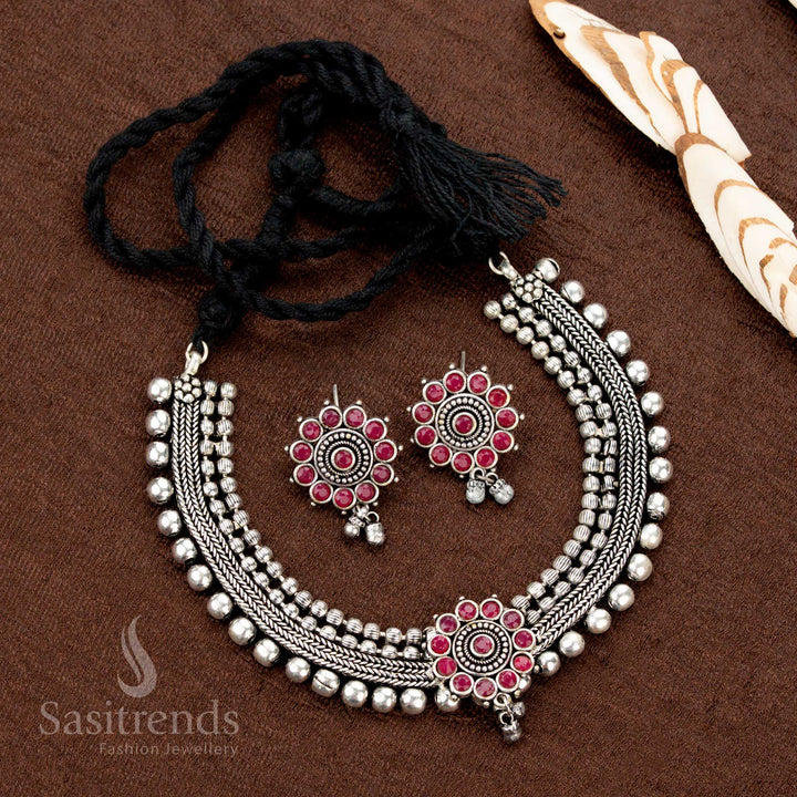 Ruby stone-studded floral choker jewellery set in oxidised silver, designed with four-line beads and matching earrings—ethnic and handcrafted with a statement-making appeal - Sasitrends