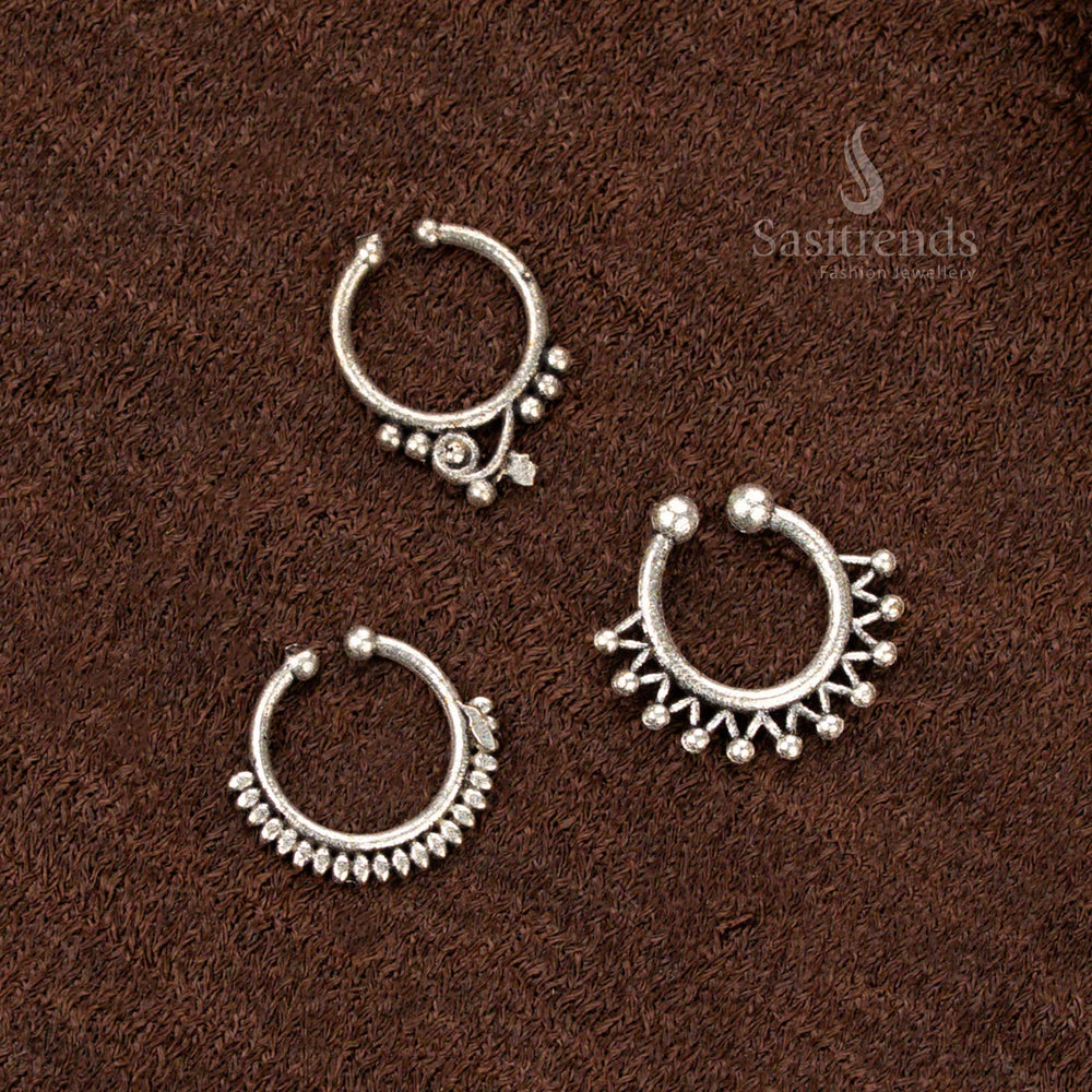 Traditional pressable oxidised nosepin with delicate floral bell design, finished in rustic silver and infused with temple-inspired beauty and a soft tribal touch by Sasitrends