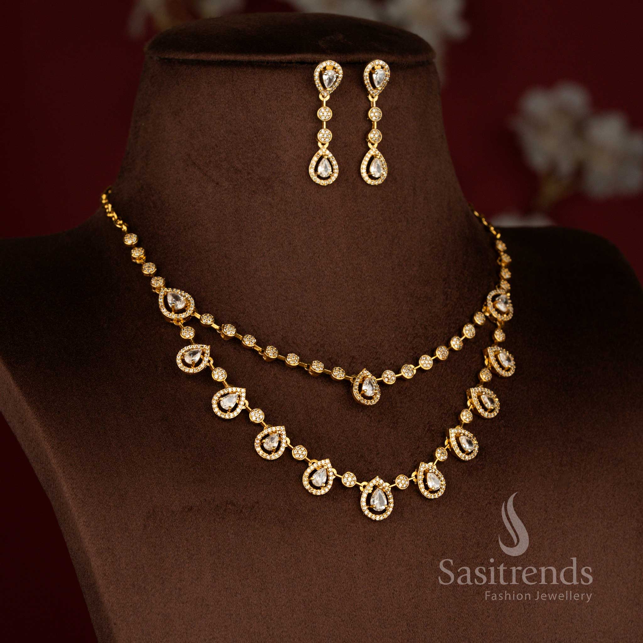 Opulent matte gold plated floral necklace set with teardrop American diamond detailing in white perfect for festive functions and bridal moments – Sasitrends