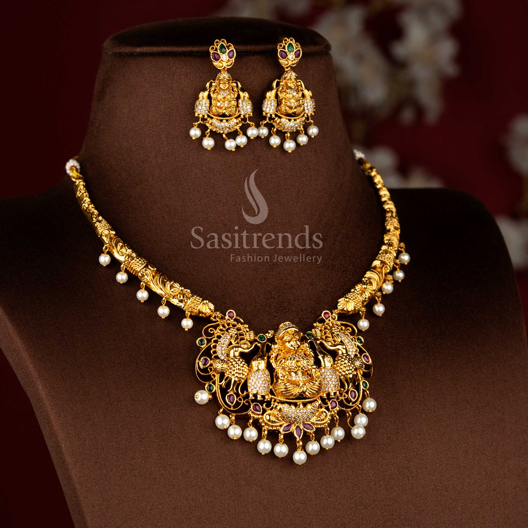 Majestic heritage matte gold plated jewellery set presenting Lakshmi icon relief with peacock themed artistry and multicolour gemstone detailing for grand rituals – Sasitrends
