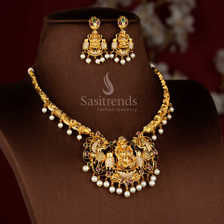 Majestic heritage matte gold plated jewellery set presenting Lakshmi icon relief with peacock themed artistry and multicolour gemstone detailing for grand rituals – Sasitrends