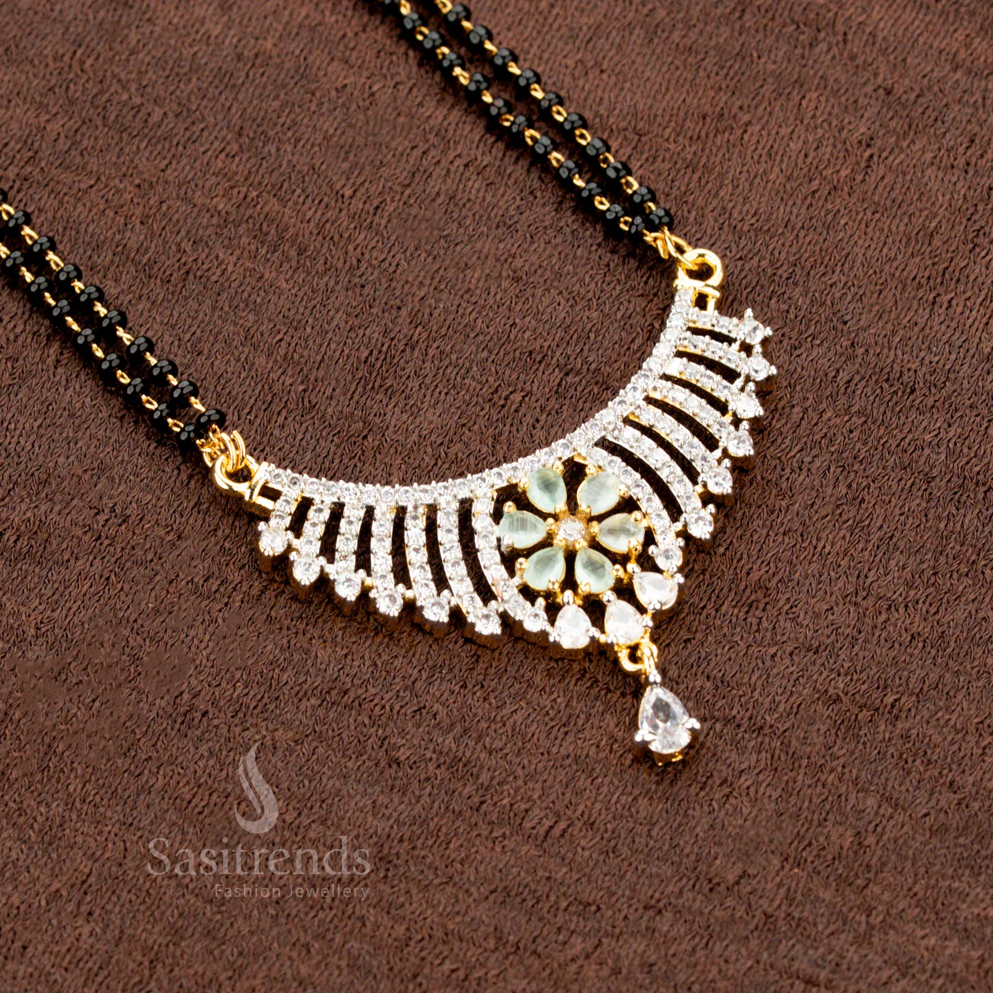 Stunning mint floral motif pendant set, designed with sparkling American Diamonds, a Mangalsutra chain, and matching earrings, making it a premium festive jewellery masterpiece - Sasitrends