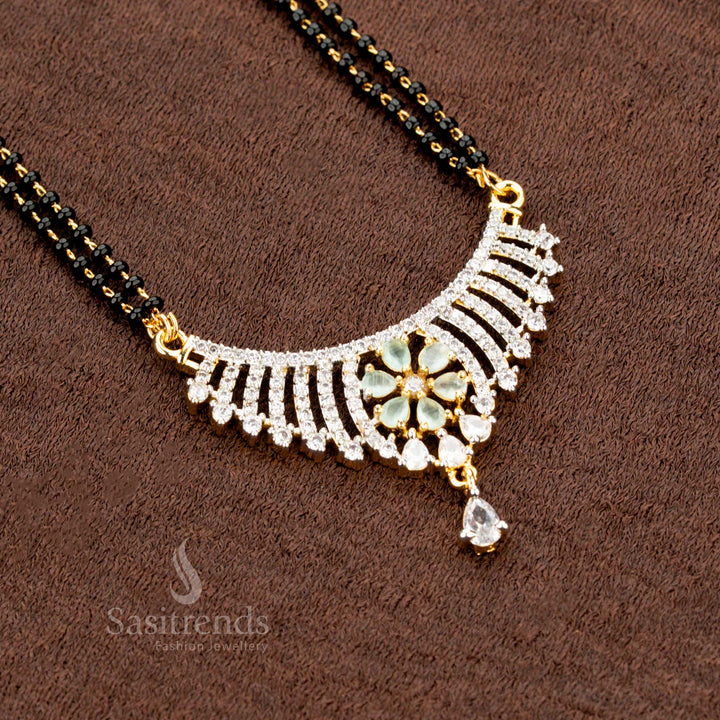 Stunning mint floral motif pendant set, designed with sparkling American Diamonds, a Mangalsutra chain, and matching earrings, making it a premium festive jewellery masterpiece - Sasitrends