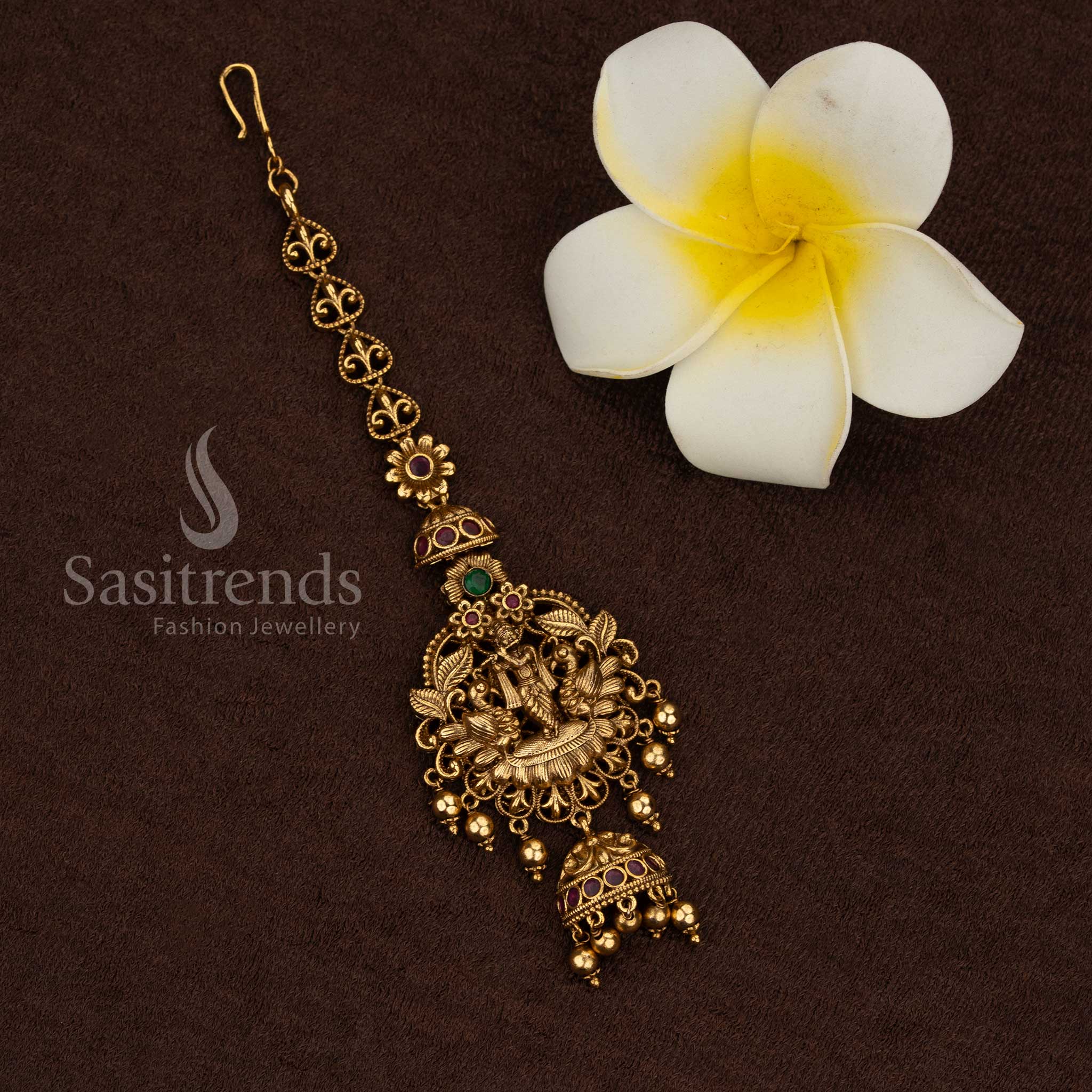 Traditional temple matte gold plated floral linked Lakshmi maang tikka with antique carving and bead drops, premium quality forehead jewellery for festive and saree wear - Sasitrends

