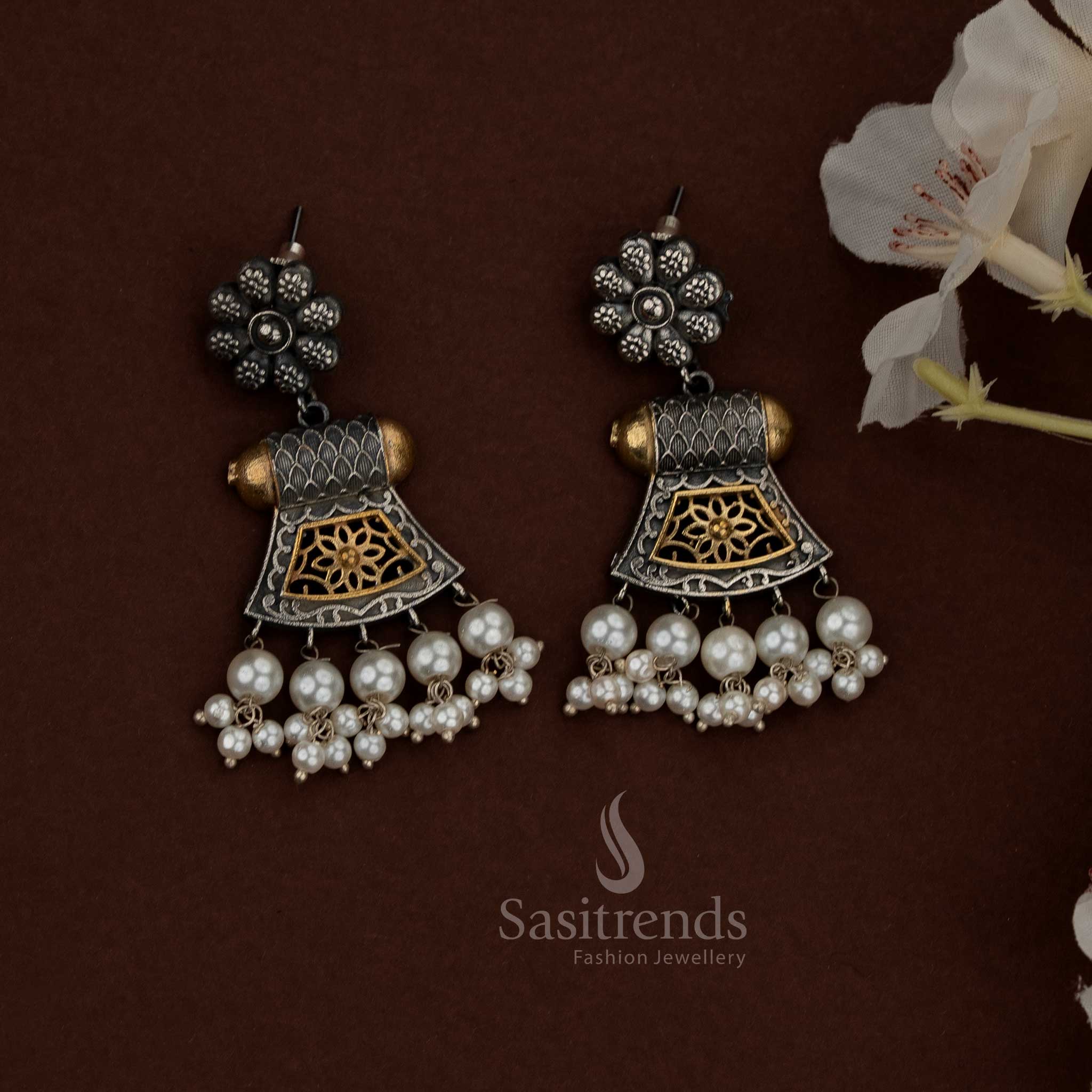 Opulent 92.5 dual tone silver oxidised plated floral jharokha necklace set created for Navaratri nights, cultural soirées, heritage-themed events, dance showcases, festive dinners, and ethnic celebrations. Features architectural jharokha forms, floral detailing, pearl drops, and expressive dual tone silver aesthetics.