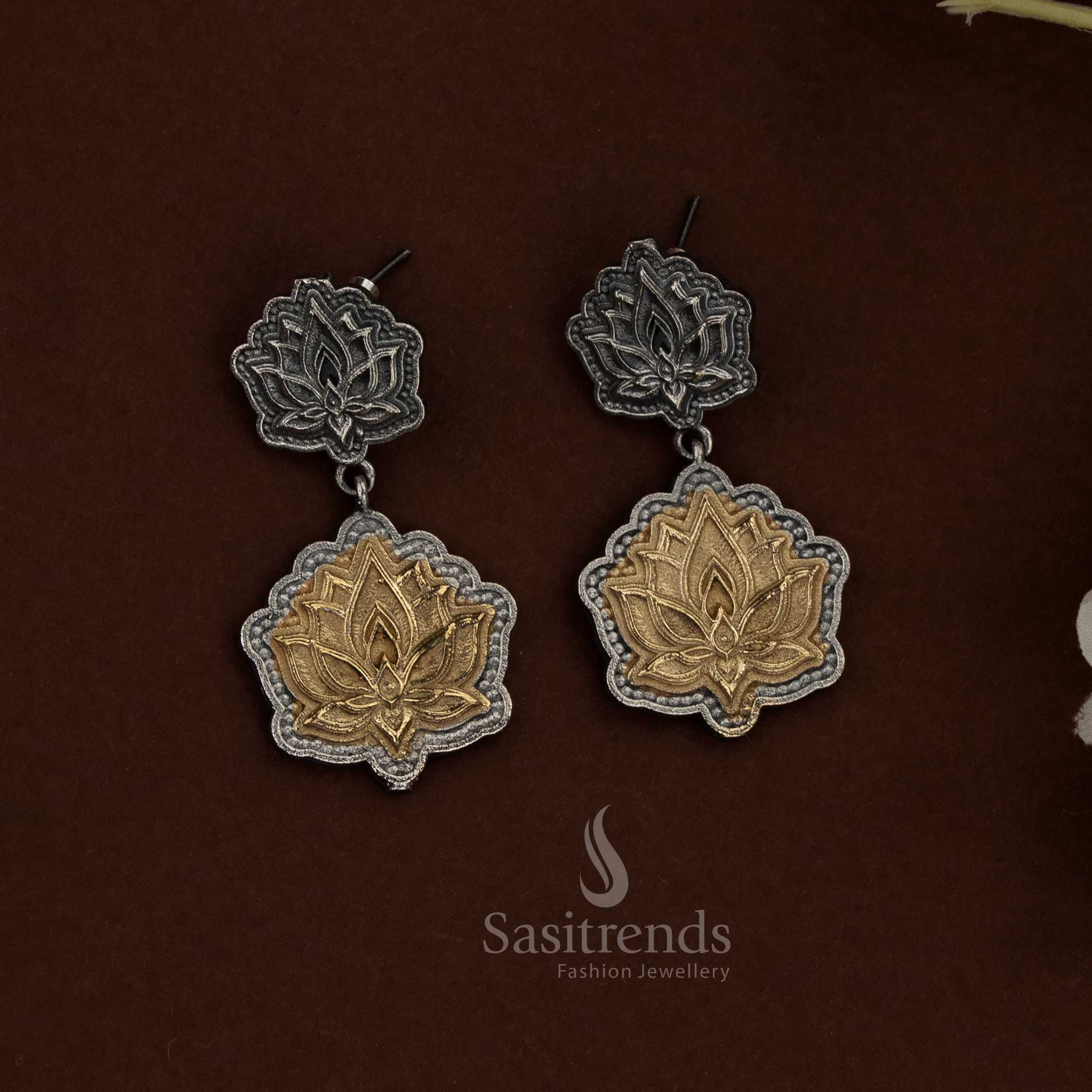 Majestic in presence, this 92.5 dual tone silver oxidised plated lotus pendant choker husli necklace set is crafted to create a powerful ethnic jewellery statement through symbolic detailing and structured artistry - Sasitrends