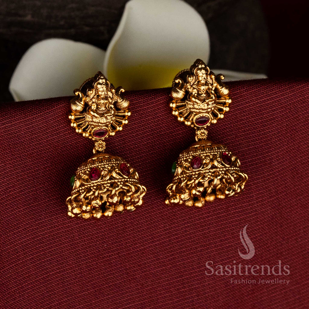 Premium matte gold plated ruby green temple dual peacock Goddess Lakshmi jhumka earrings with screw type back for ceremonial and festive wear-sasitrends