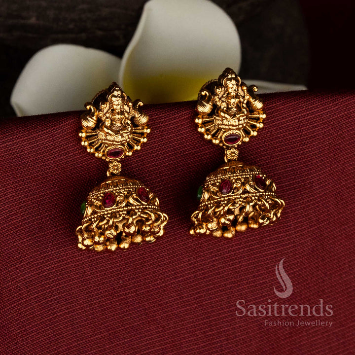 Regal Matte Gold Plated Temple Dual Peacock Goddess Lakshmi Jhumka Earrings with Floating Gold Beads