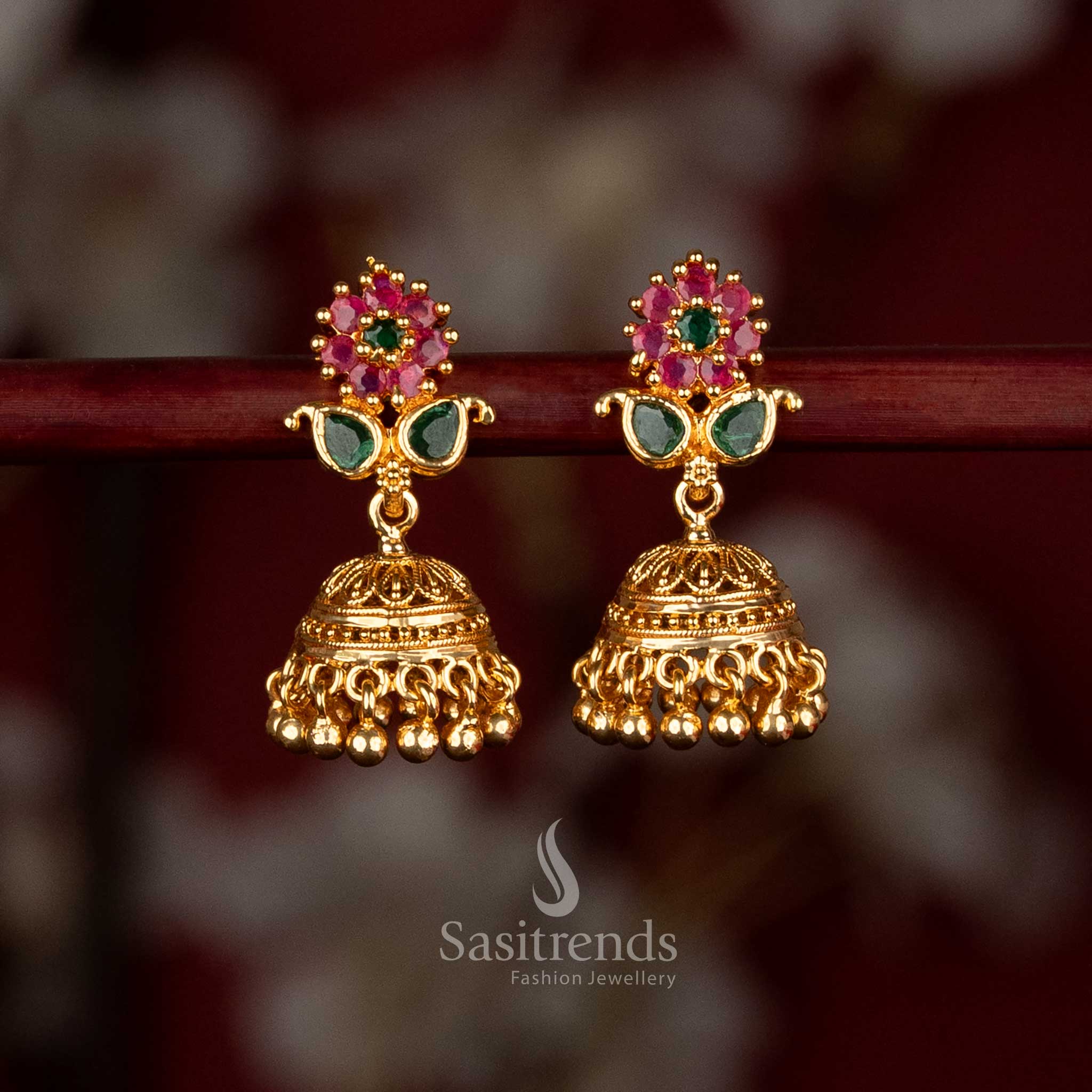 One gram 24K micro gold plated traditional ruby green AD stone jhumka earrings featuring floral stud and hanging bead detailing