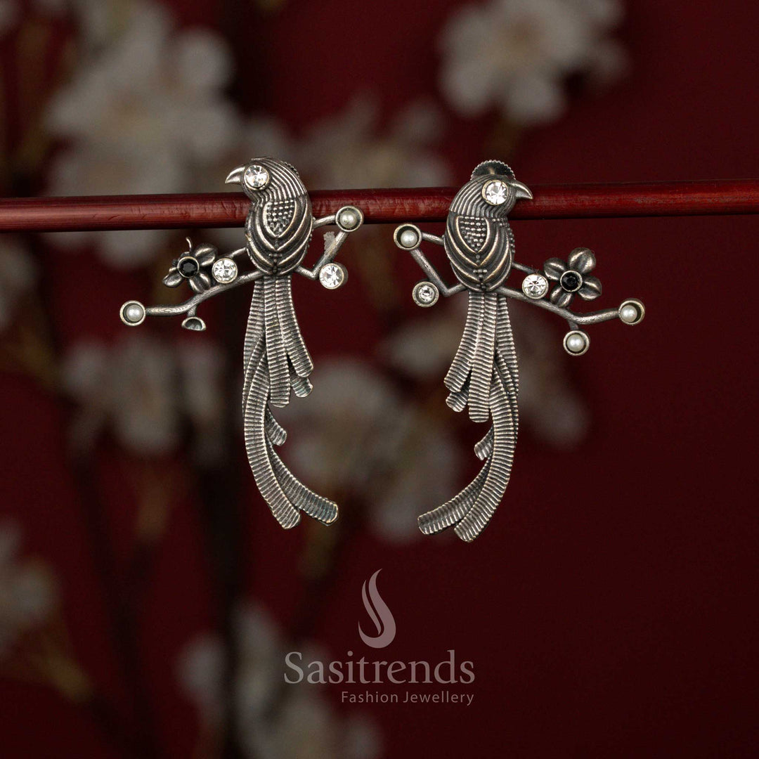 Sasitrends white black oxidised German silver stone earrings featuring a detailed twin bird motif, layered feather texture craftsmanship and branch-inspired sculpted structure for bold ethnic and tribal styling.