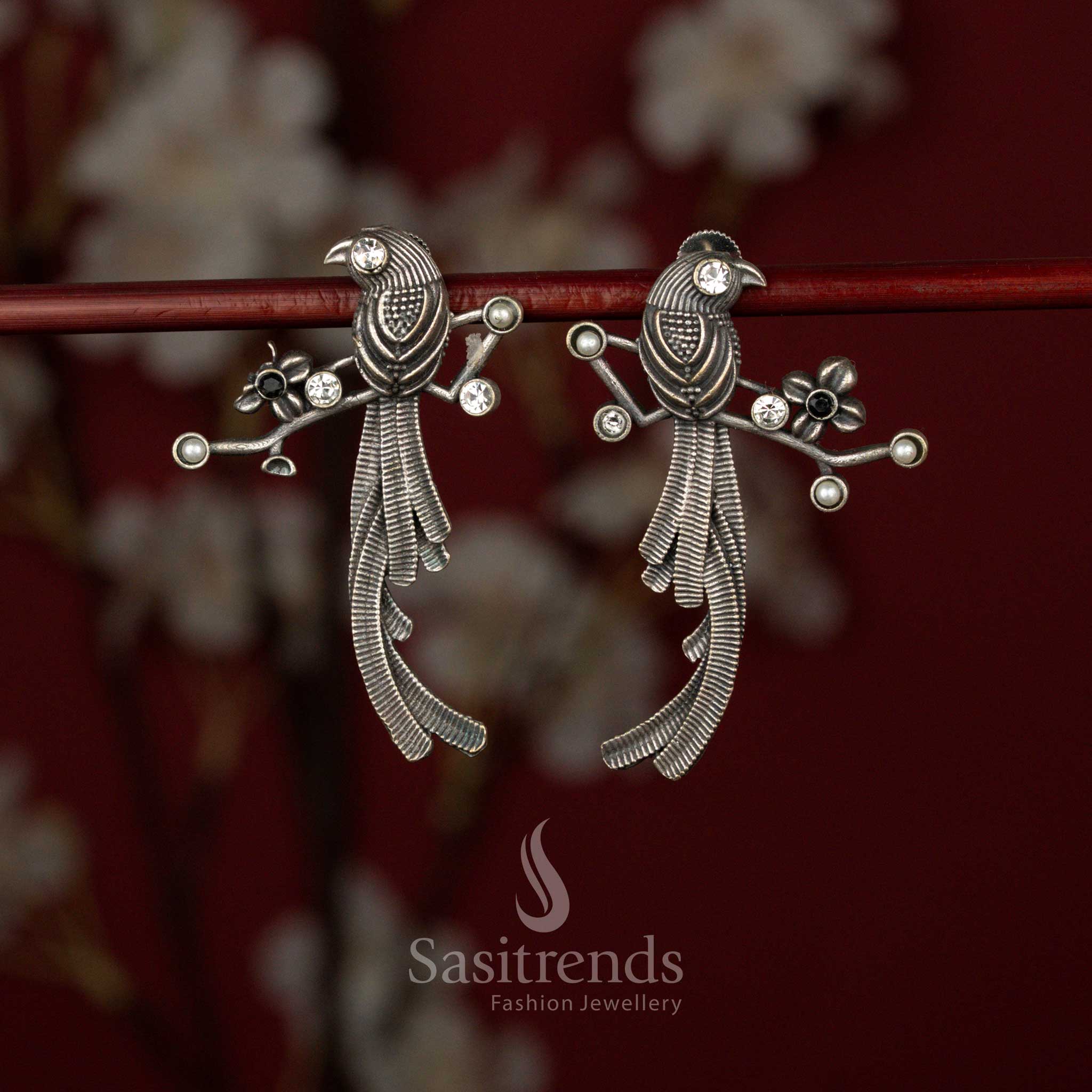 Sasitrends white black oxidised German silver stone earrings featuring a detailed twin bird motif, layered feather texture craftsmanship and branch-inspired sculpted structure for bold ethnic and tribal styling.