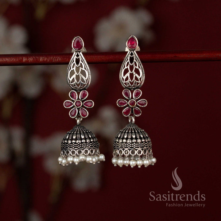 Sasitrends ruby oxidised German silver jhumka earrings featuring a Monalisa teardrop cut stone, intricate floral motif detailing and graceful pearl hangings, perfect for sarees, silk kurtis and festive occasions.