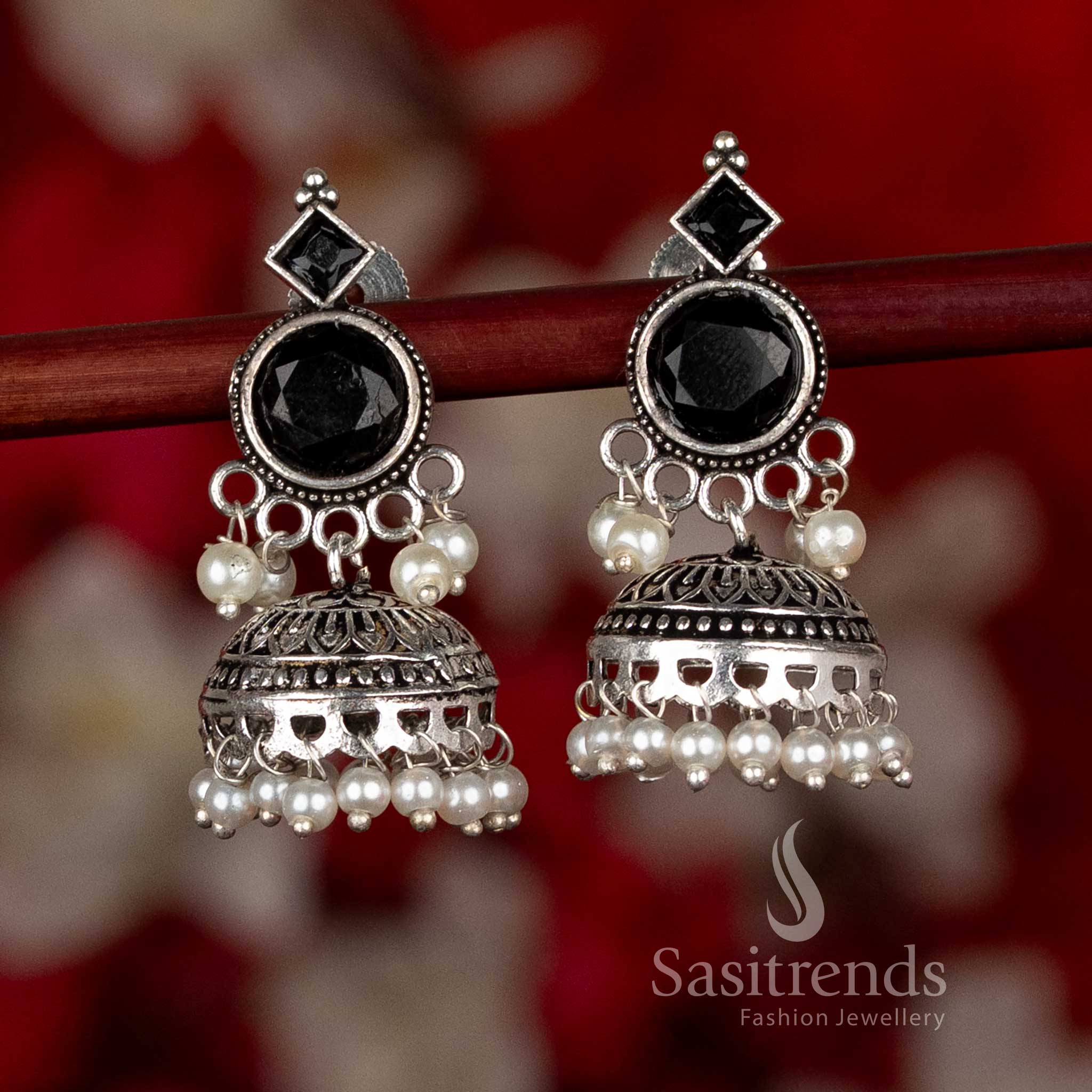 Oxidised silver plated jhumka earrings by Sasitrends featuring a circular stud and dome-shaped structure with engraved patterns and pearl hangings in a black color variant, ideal for ethnic wear, casual wear, office wear, and modern saree styling
