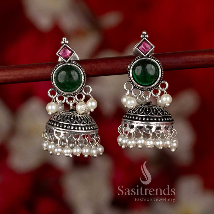 Oxidised silver plated jhumka earrings from Sasitrends designed with circular stud tops, detailed dome structure, and pearl hangings in a green and ruby color combination, ideal for ethnic wear, casual wear, office wear, and modern saree outfits
