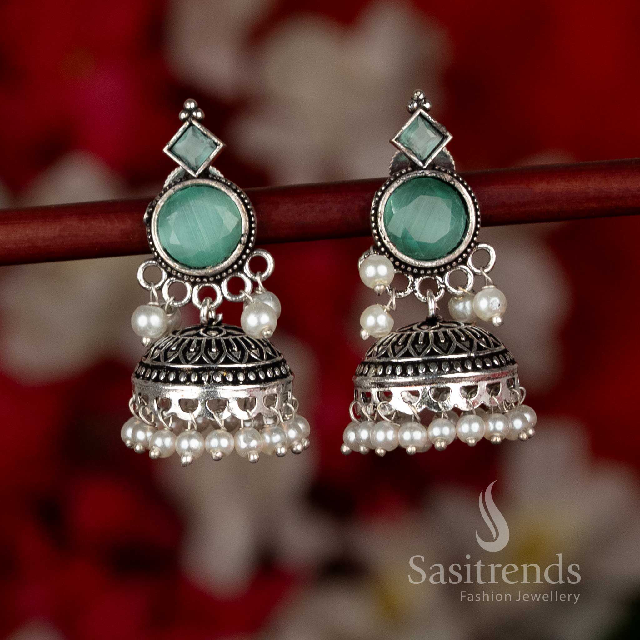 Sasitrends oxidised silver plated jhumka earrings showcasing circular stud tops, engraved dome-shaped structure, and pearl detailing in a mint color tone, suitable for ethnic wear, casual wear, office wear, and contemporary saree styling
