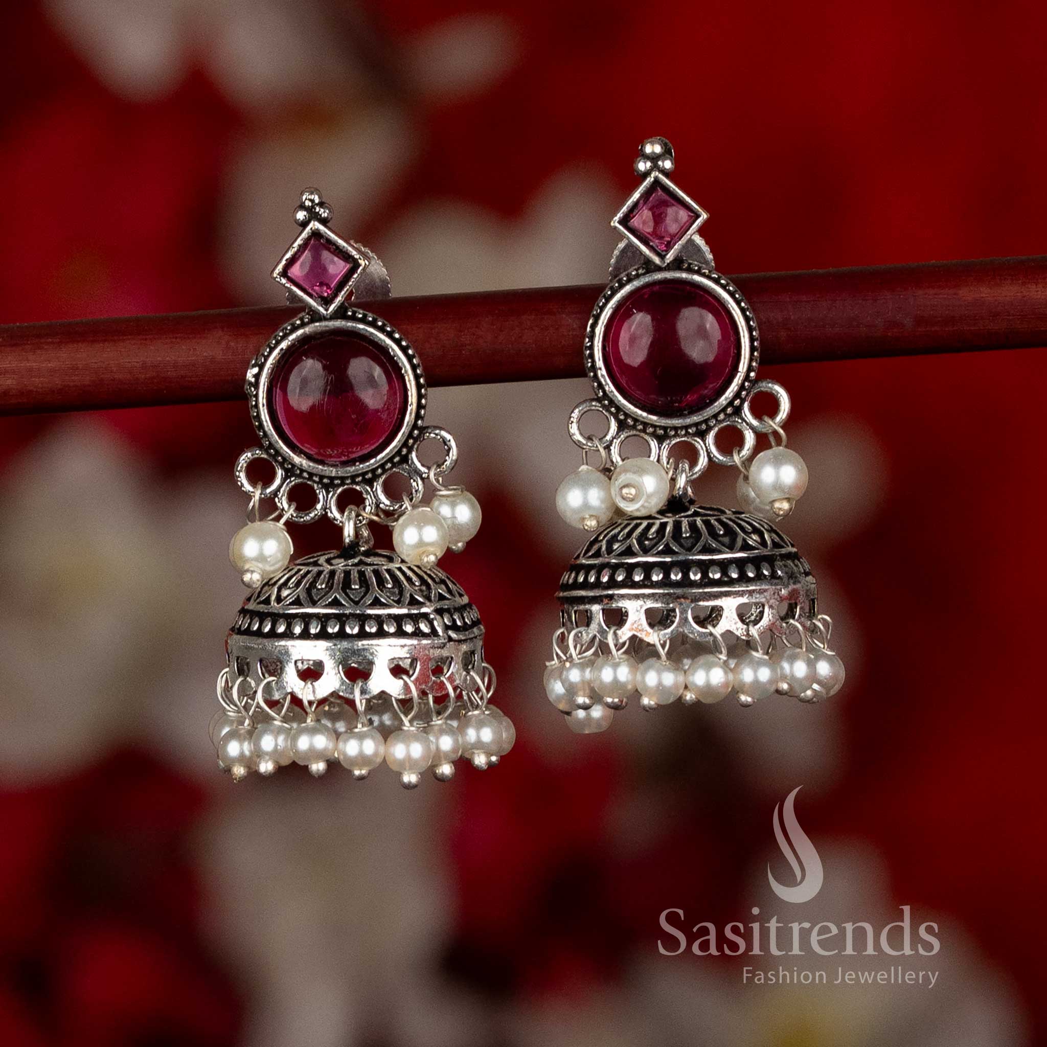 Oxidised silver plated jhumka earrings from Sasitrends featuring circular stud design, layered dome structure with cutwork detailing, and pearl hangings in a ruby color variant, perfect for ethnic wear, festive occasions, office wear, and modern saree outfits
