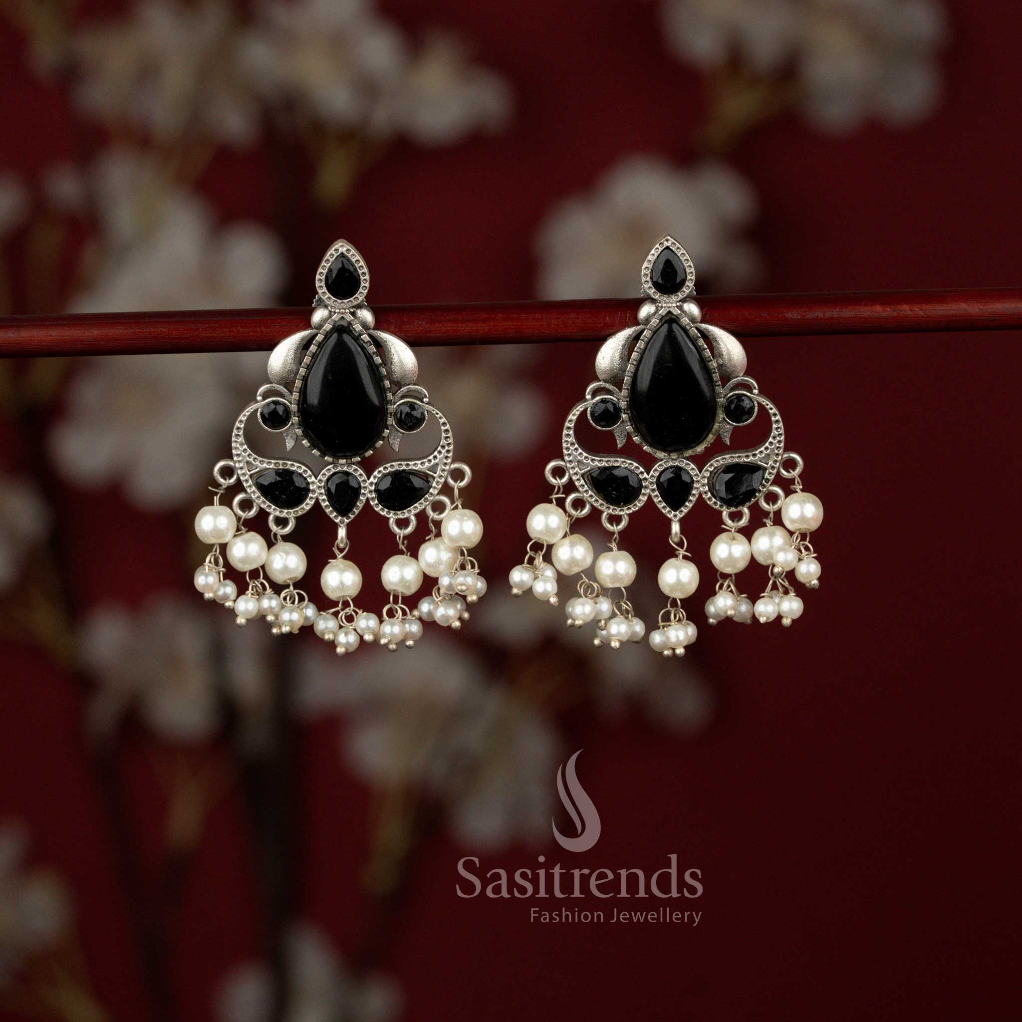Sasitrends black Peacock Eleganza oxidised silver earrings featuring a graceful peacock motif, radiant teardrop stone detailing and delicate pearl hangings, beautifully suited for Navaratri celebrations, sarees and traditional ethnic attire.