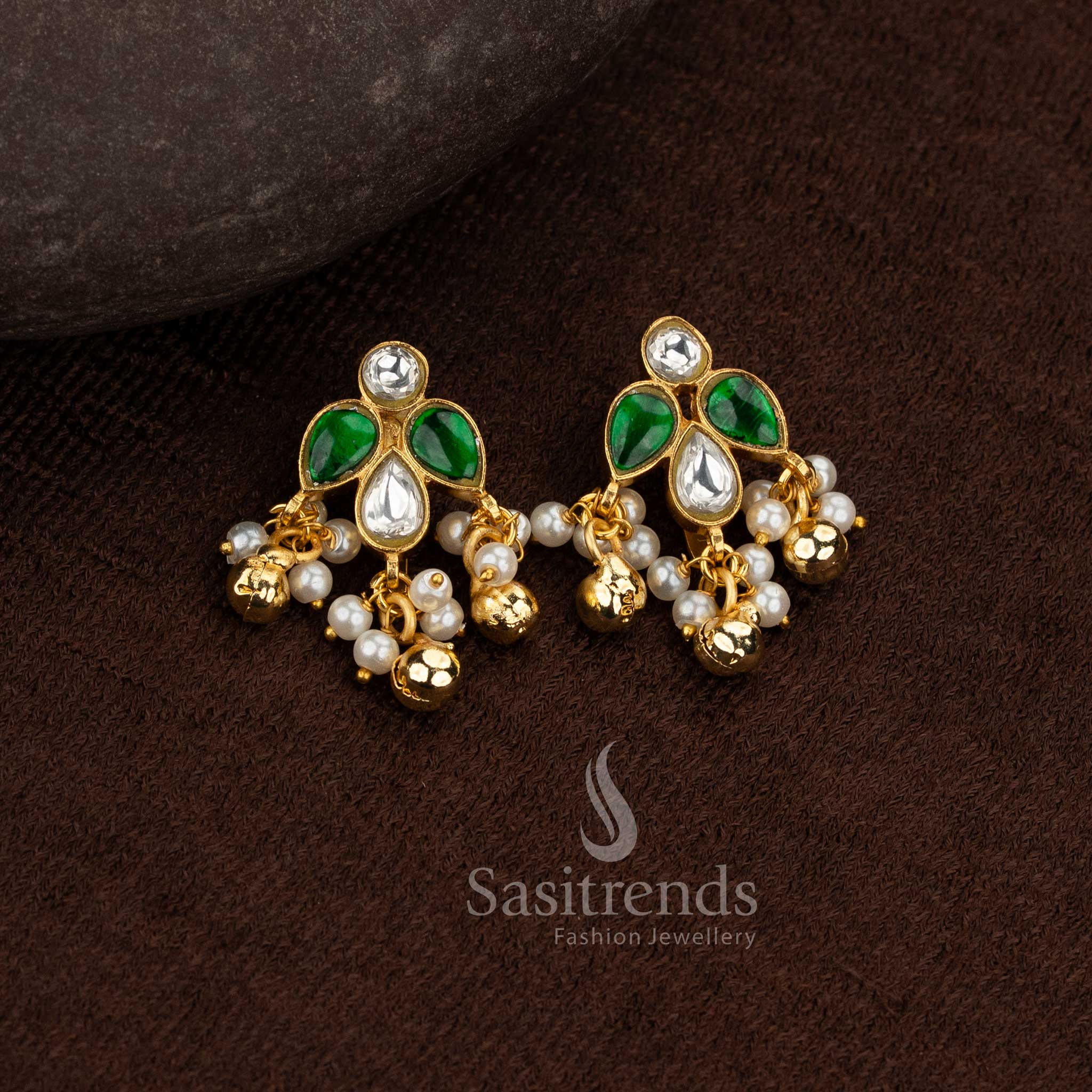 Sasitrends 24k jadau gold plated traditional white green kundan stone bugadi ear cuff earrings designed with leaf motif structure and pearl hanging accents creating a premium heritage look
