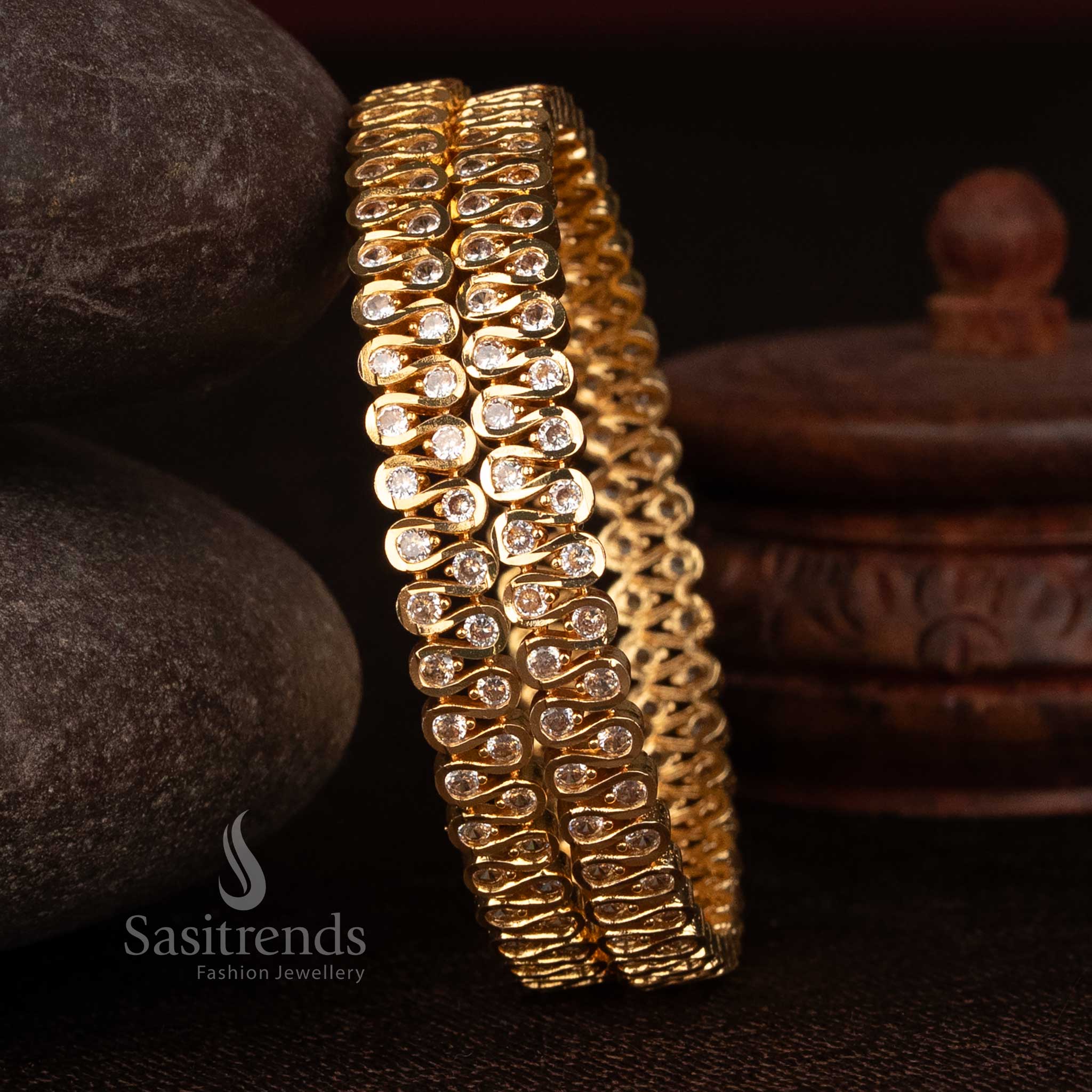 Sasitrends 24K micro gold plated impon S-curve bangle featuring round white AD stone detailing crafted for traditional attire and festive occasions
