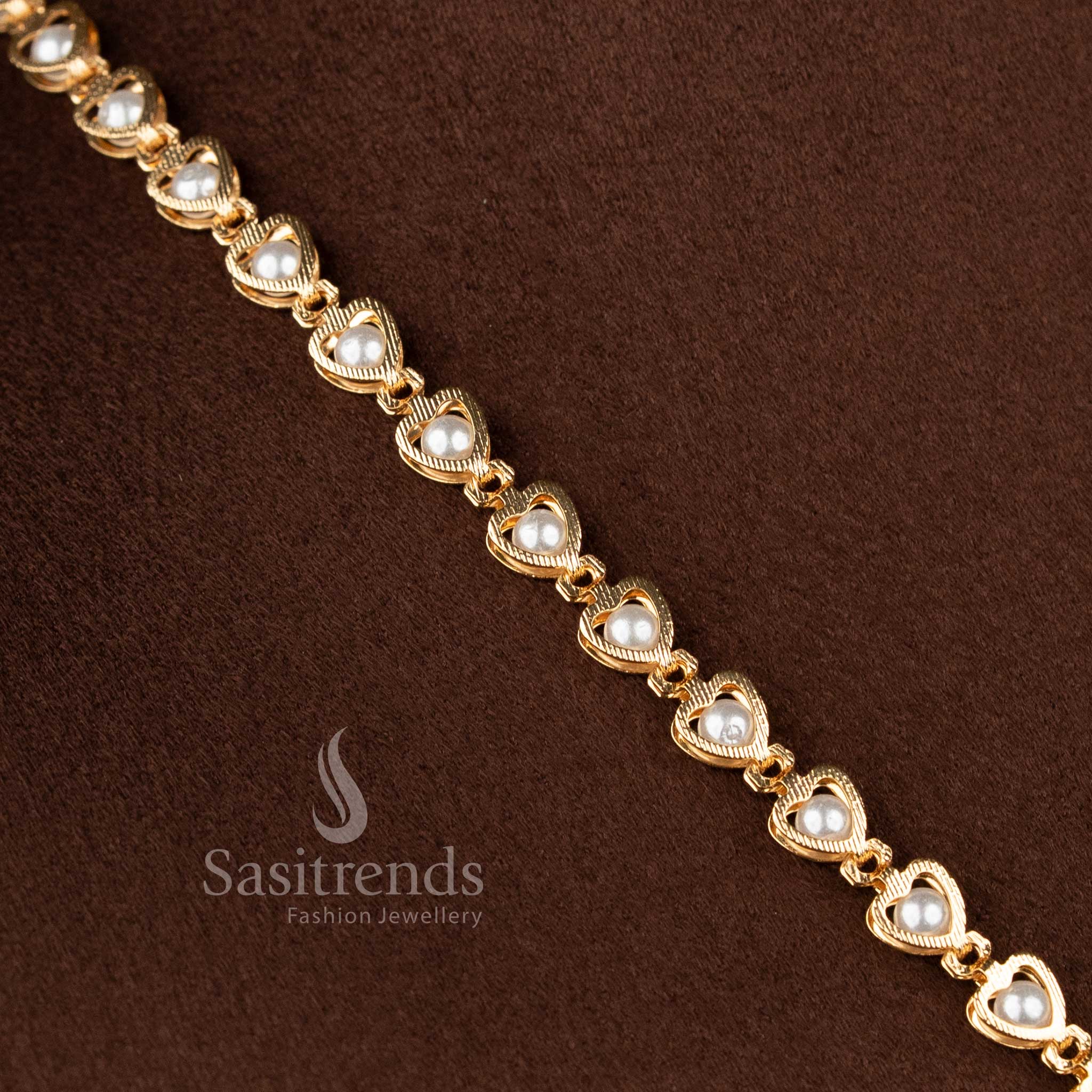Sasitrends 24K micro gold plated peacock floral pendant necklace featuring pearl detailing with ruby and green AD stones crafted for festive and traditional styling