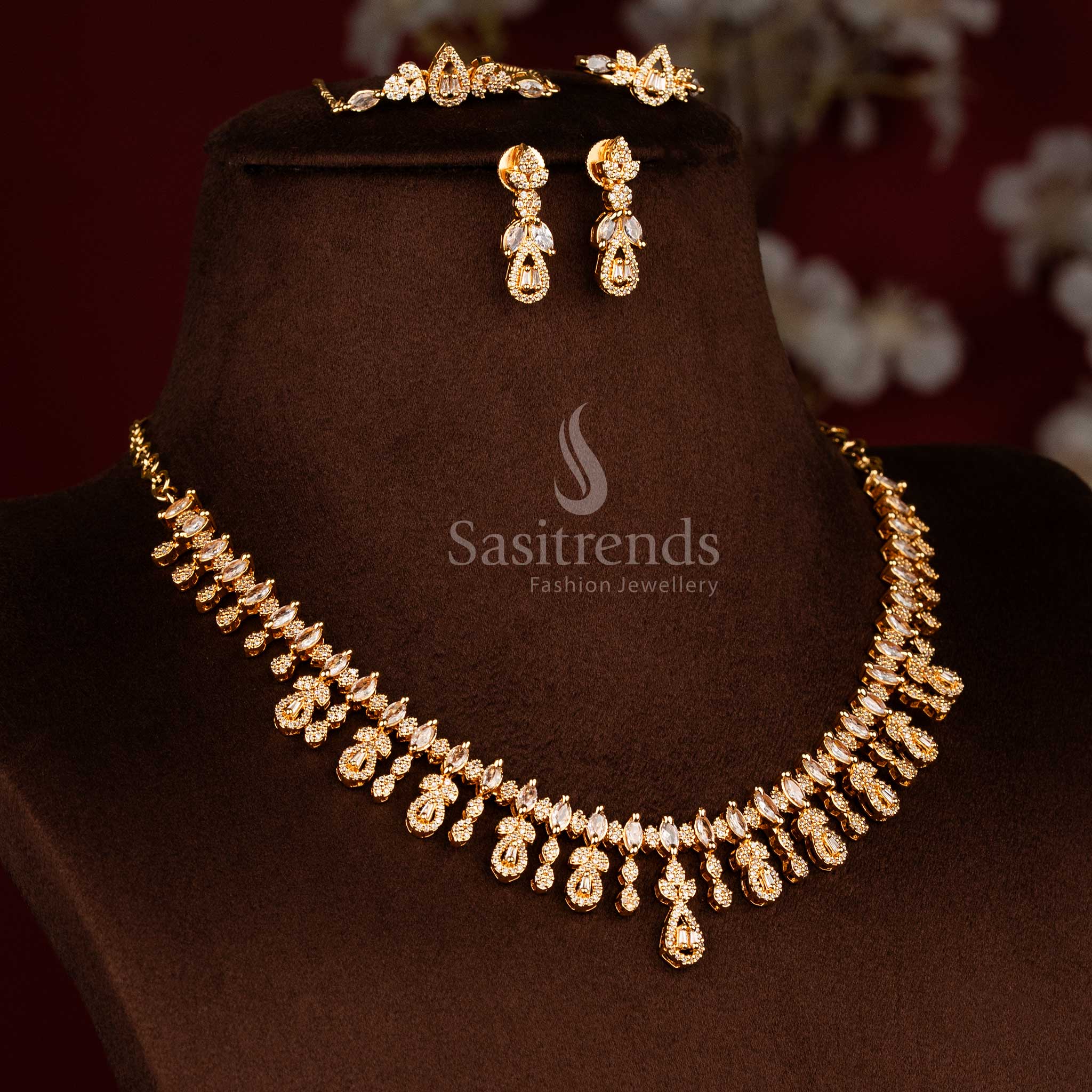 24K micro gold plated white American diamond necklace set featuring repeating teardrop drop motifs, continuous stone alignment, and layered design structure - Sasitrends