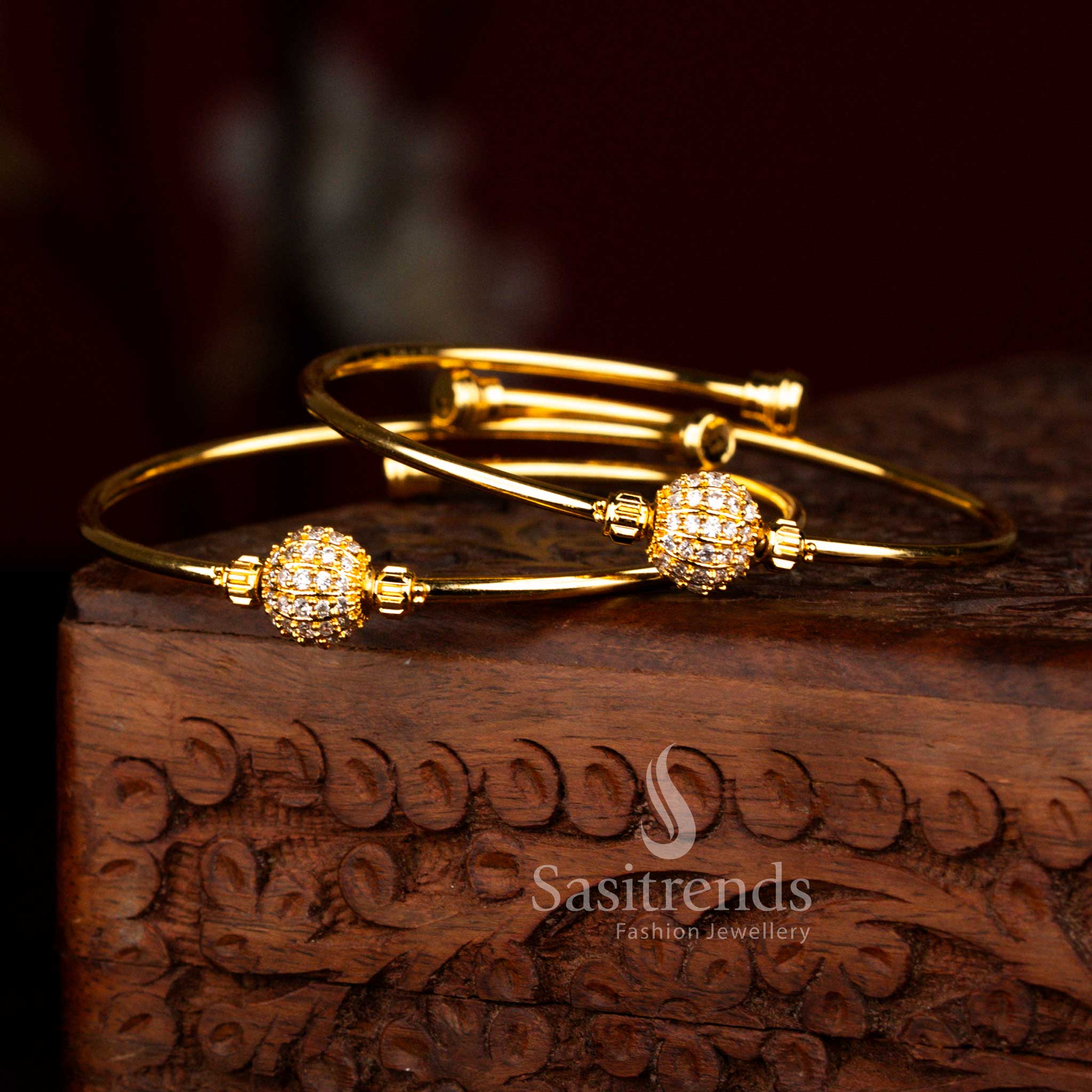 Elegant Party wear micro gold plated bangle with shimmering white American Diamond ball detailing and smooth gold finish