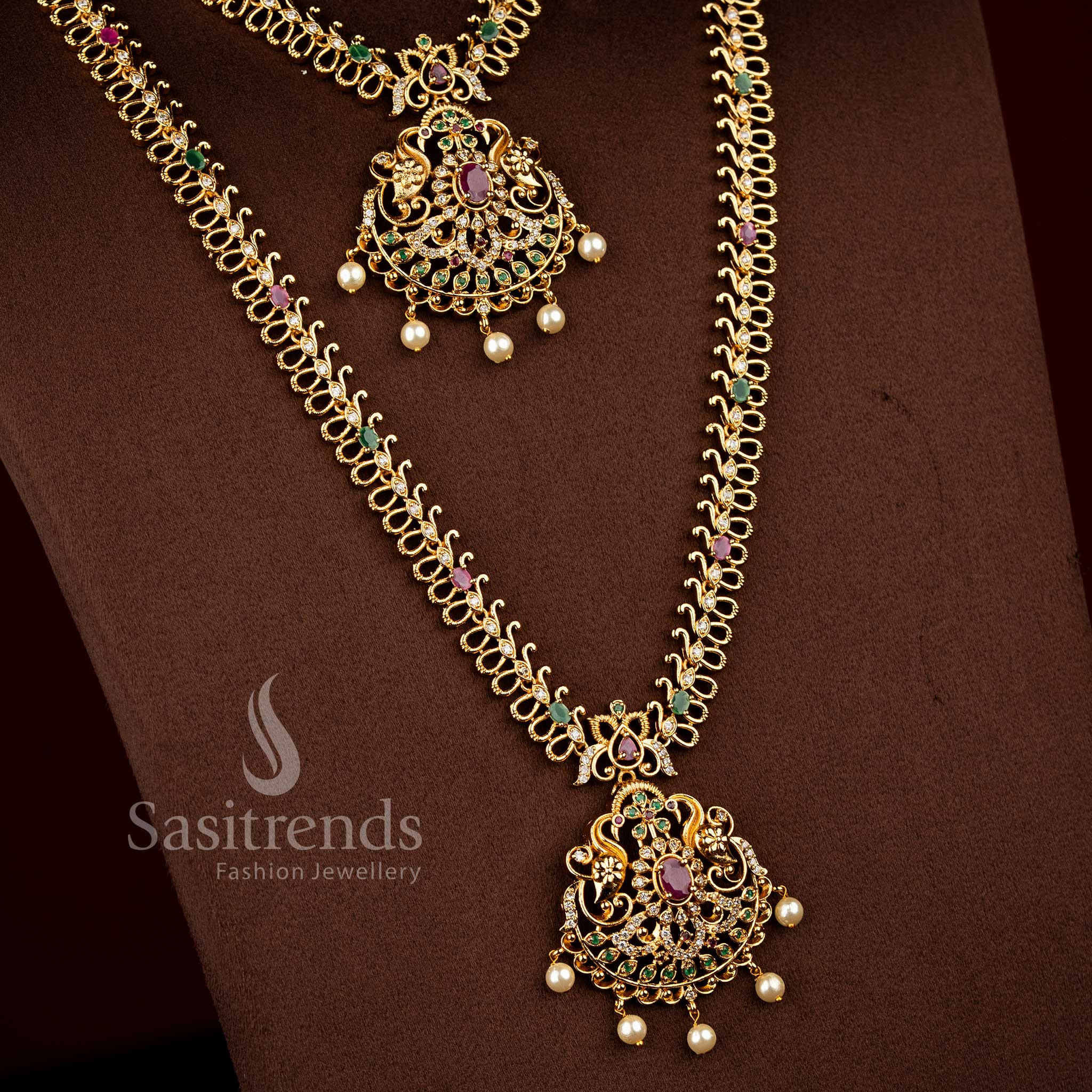 Sasitrends traditional temple matte gold plated multi AD stone jewellery set featuring layered short and long chains with detailed peacock floral medallion pendants 