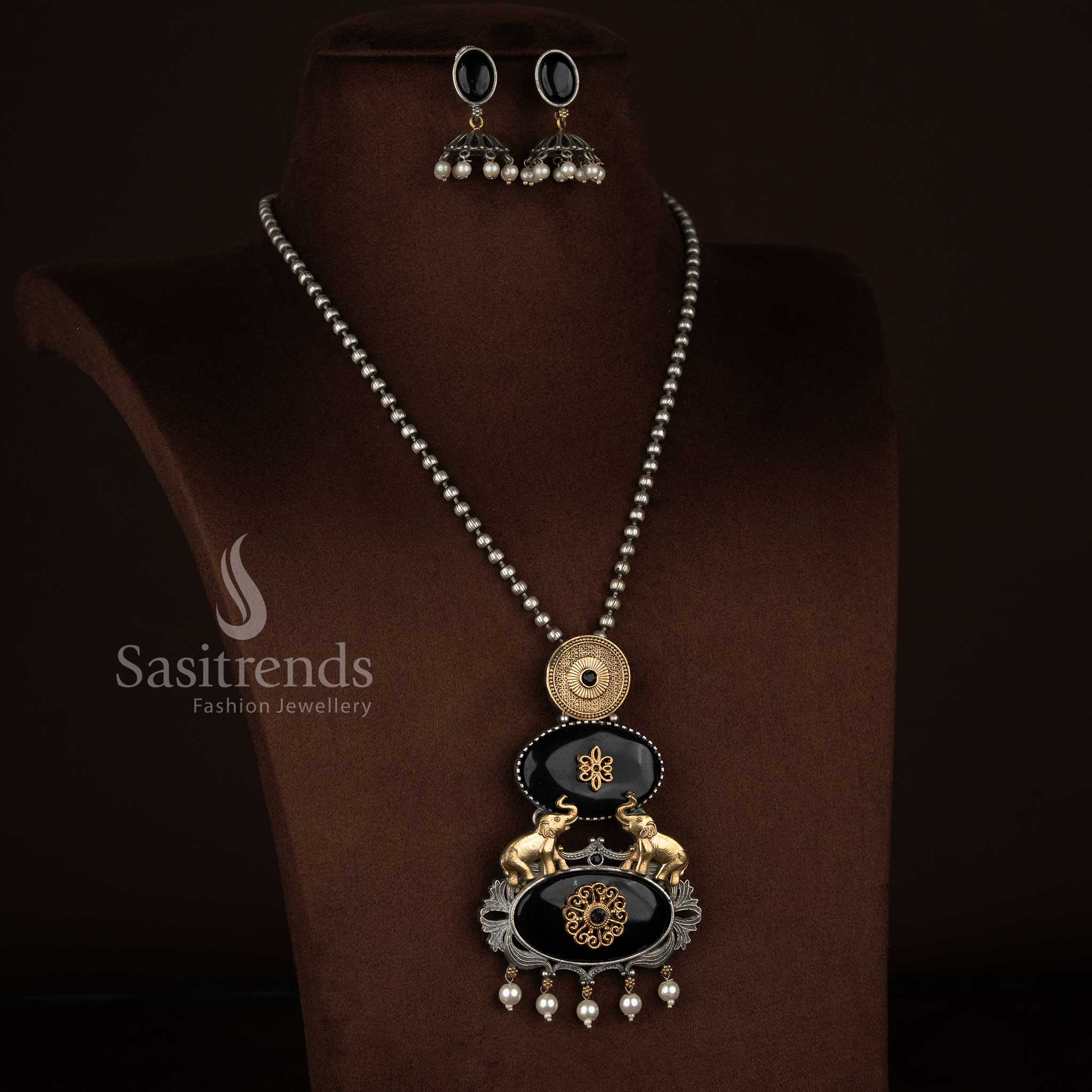 Sasitrends oxidised 92.5 silver plated necklace set featuring a structured vertical pendant design with embossed medallion, floral Monalisa centre, elephant motifs, pearl drop accents and oxidised beaded chain with earrings – black variant
