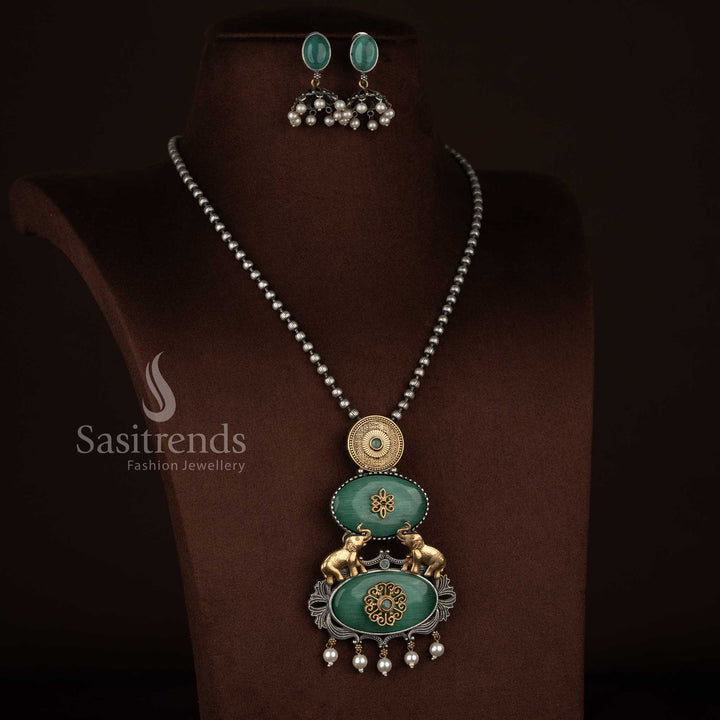 Sasitrends oxidised 92.5 silver plated necklace set designed with a vertical pendant structure showcasing embossed silver medallion, floral Monalisa panel, heritage elephant motifs, pearl drop detailing and coordinated earrings – mint colour option
