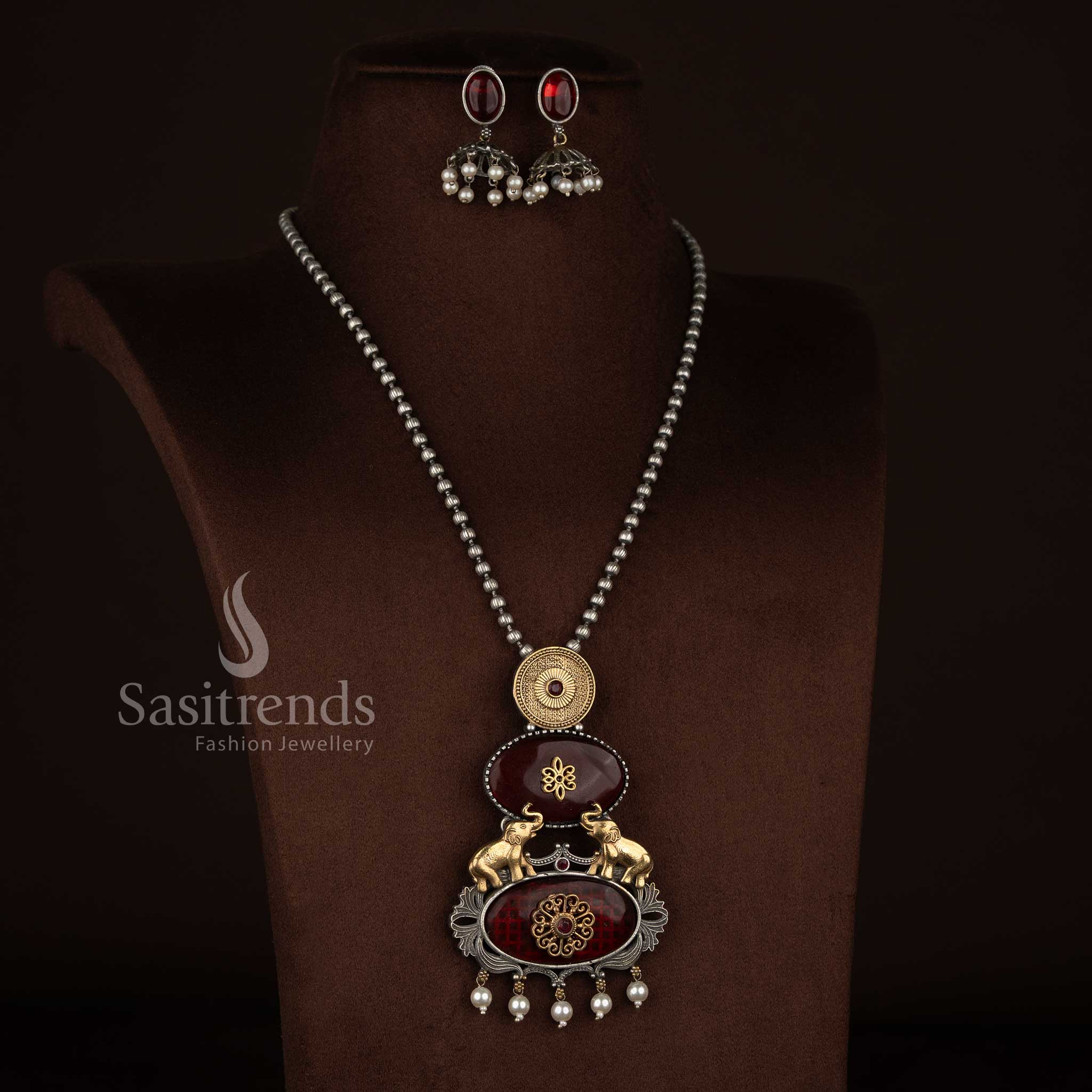 Sasitrends antique oxidised 92.5 silver plated necklace jewellery set with vertical panel red Monalisa stone pendant, embossed medallion, elephant motifs, floral detailing, pearl bead danglers, oxidised silver beaded chain and matching earrings