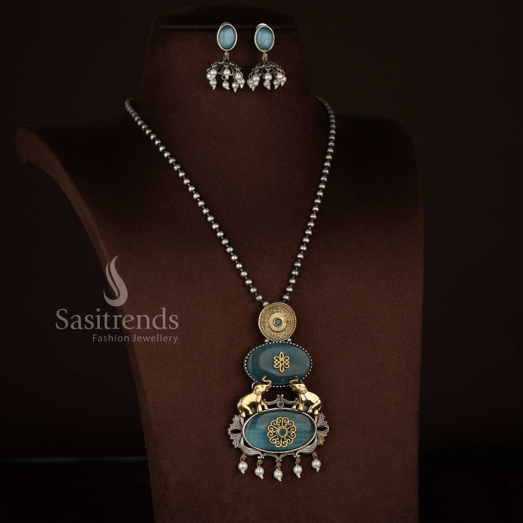 Sasitrends antique oxidised silver plated necklace jewellery set showcasing a vertical pendant composition with embossed silver medallion, floral Monalisa detailing, elephant motifs, pearl bead danglers and matching earrings – Sky blue shade
