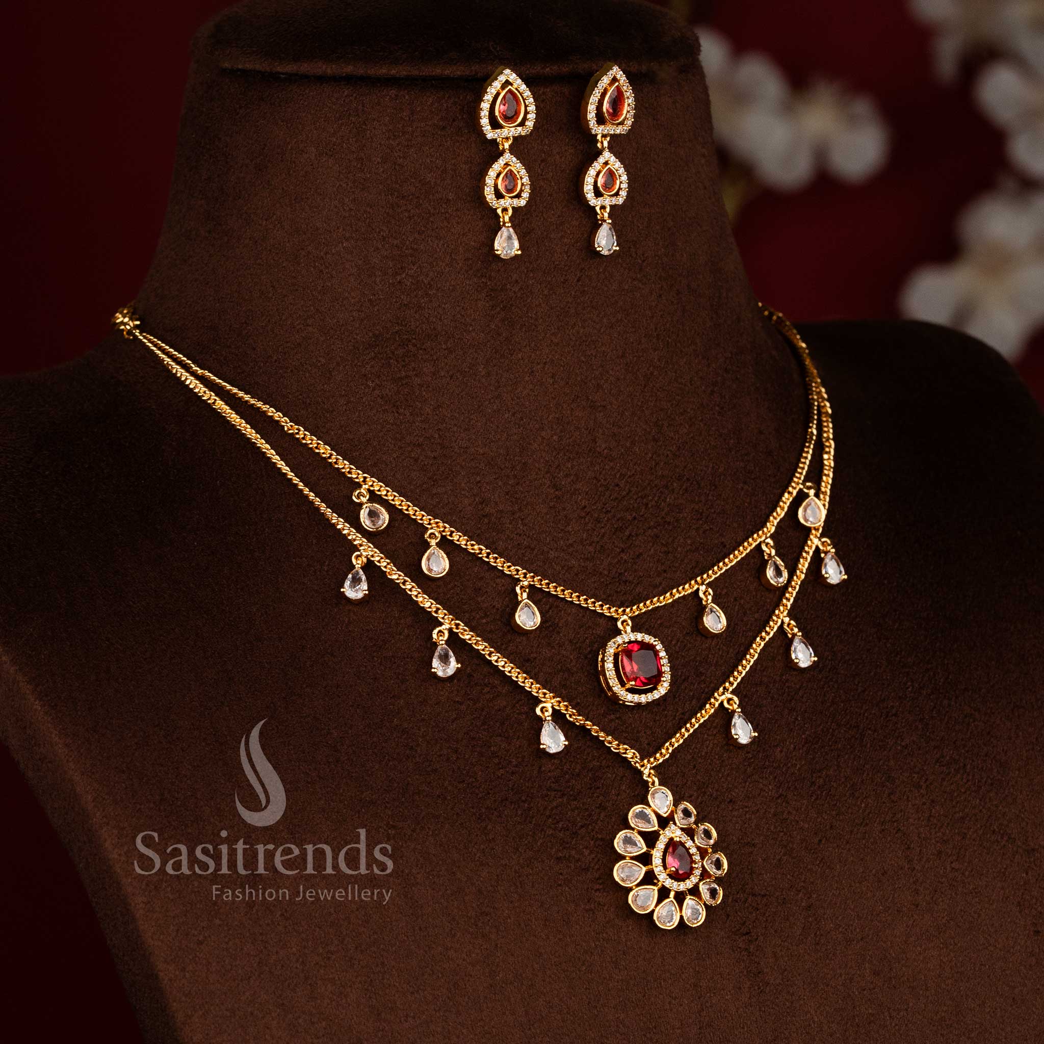 Micro gold plated two layer necklace set featuring teardrop white red American diamond danglers, floral pendant design, and matching drop earrings by Sasitrends