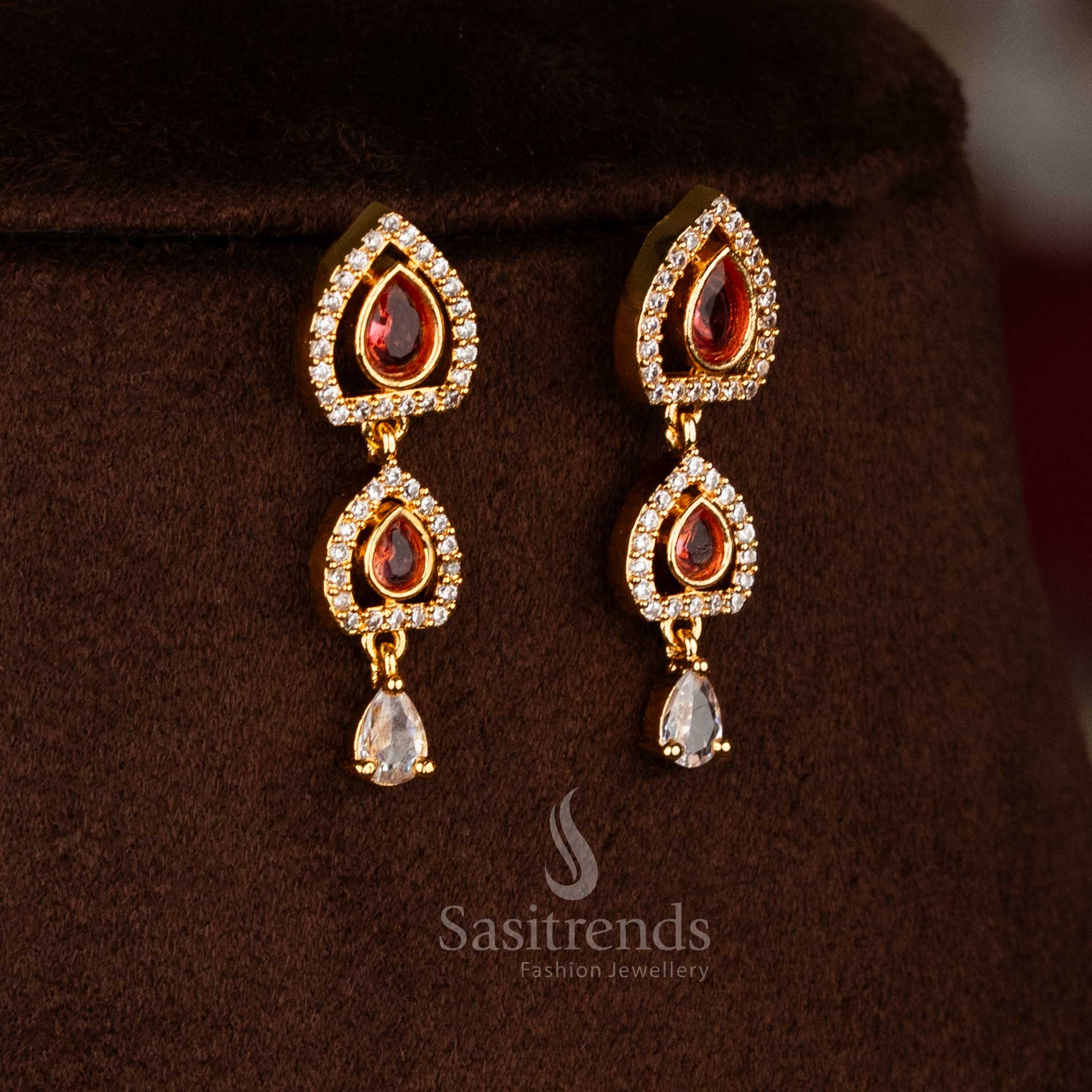 Sasitrends one gram micro gold plated necklace set designed with layered chains, ruby-tone floral pendant, and teardrop white red American diamond accents