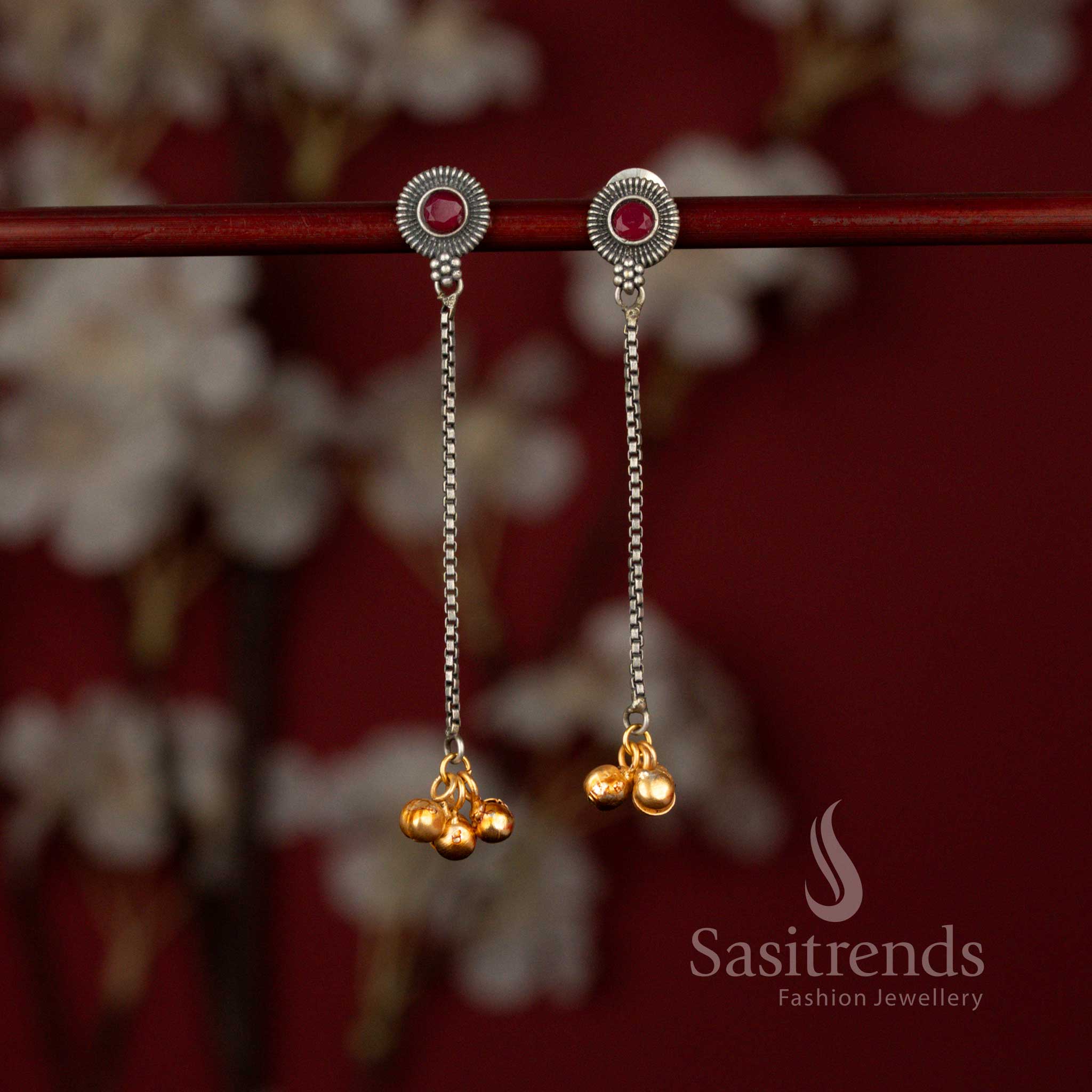 Sasitrends exquisite antique 92.5 silver plated oxidised dangler earrings featuring a radiant sunburst ruby stone motif connected to a graceful linear chain design, beautifully finished with delicate golden bead accents for ethnic wear.