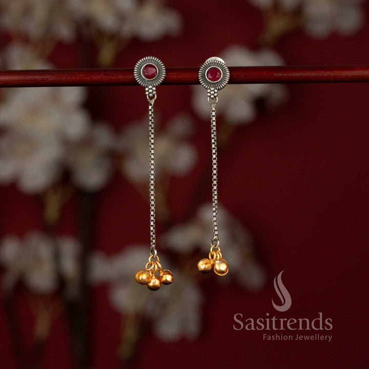 Sasitrends exquisite antique 92.5 silver plated oxidised dangler earrings featuring a radiant sunburst ruby stone motif connected to a graceful linear chain design, beautifully finished with delicate golden bead accents for ethnic wear.