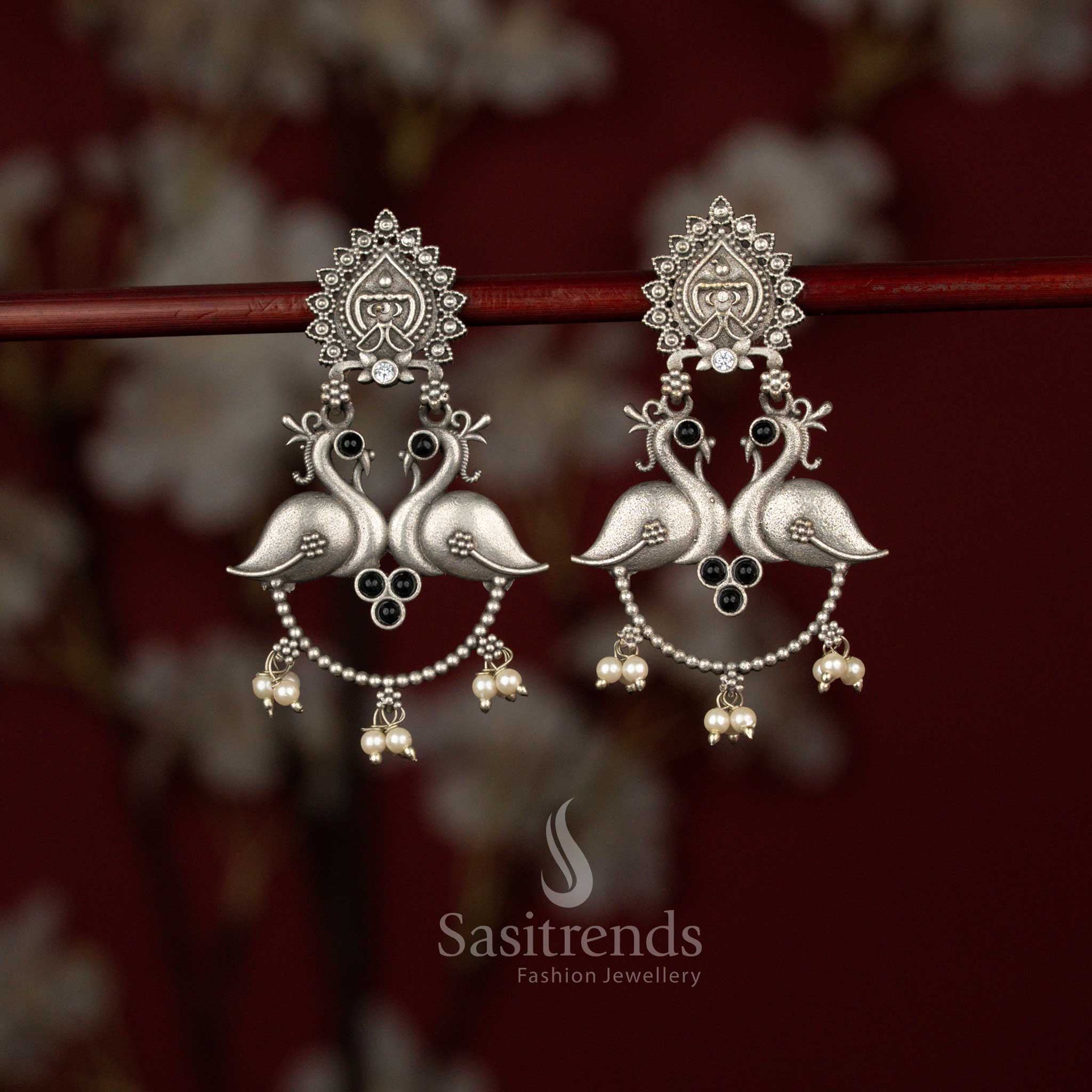 Sasitrends elegant antique black oxidised silver plated peacock motif drop earrings designed with a temple inspired stud, gracefully curved beaded chain and delicate pearl hangings for rich traditional styling.