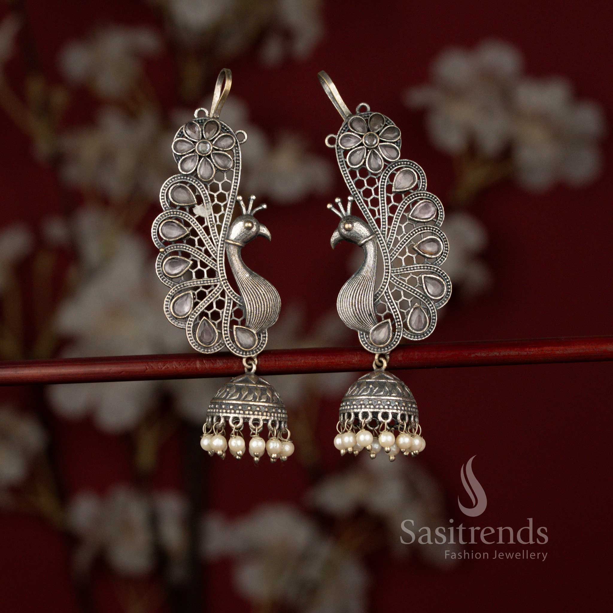 Sasitrends pink antique 92.5 silver plated oxidised peacock floral earcuff jhumka earrings featuring a detailed teardrop stone design, intricate metal artistry and delicate pearl hangings perfect for sarees and celebration wear.