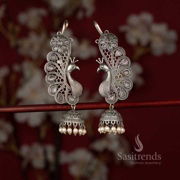 Sasitrends pink antique 92.5 silver plated oxidised peacock floral earcuff jhumka earrings featuring a detailed teardrop stone design, intricate metal artistry and delicate pearl hangings perfect for sarees and celebration wear.