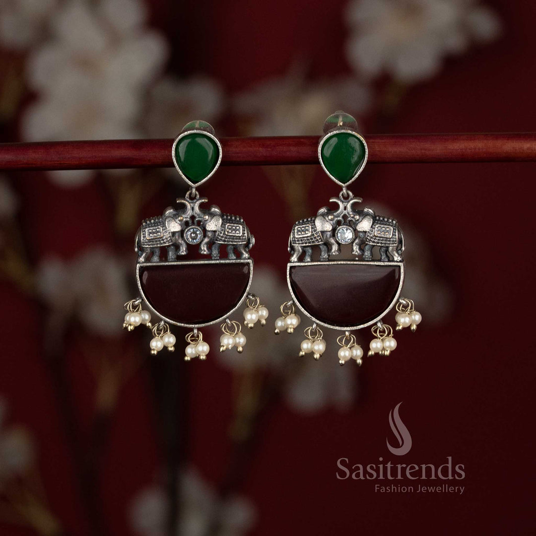 Sasitrends antique oxidised statement green maroon stone earrings featuring sculpted elephant motifs and structured half-moon base