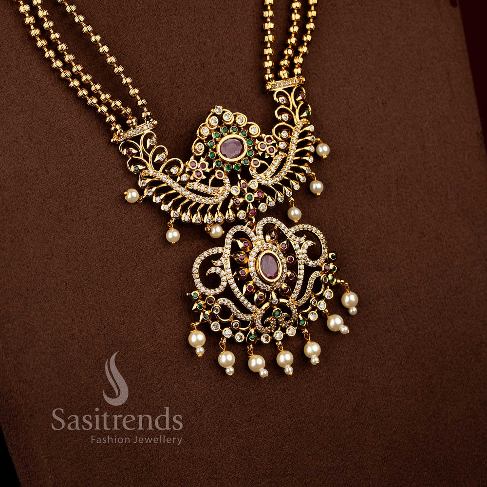 Sasitrends bridal temple matte gold plated multi AD stone long necklace set featuring triple layered chain design with ornate peacock floral centre pendant