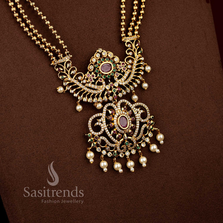 Sasitrends bridal temple matte gold plated multi AD stone long necklace set featuring triple layered chain design with ornate peacock floral centre pendant
