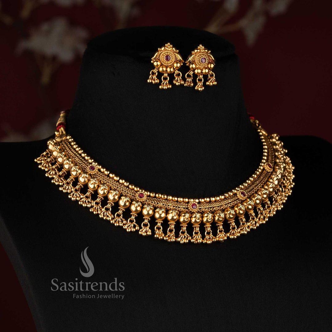 Sasitrends antique gold plated traditional temple style broad choker necklace set with floral scroll motifs, layered beads and hanging ornamental drops