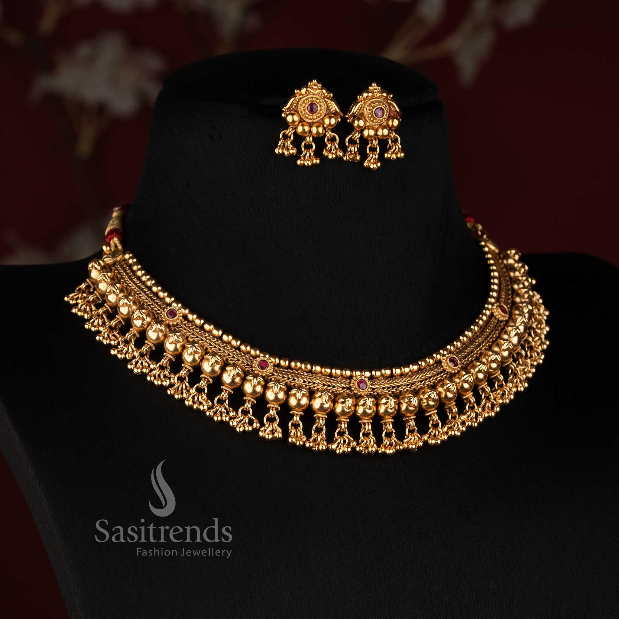 Sasitrends antique gold plated traditional temple style broad choker necklace set with floral scroll motifs, layered beads and hanging ornamental drops